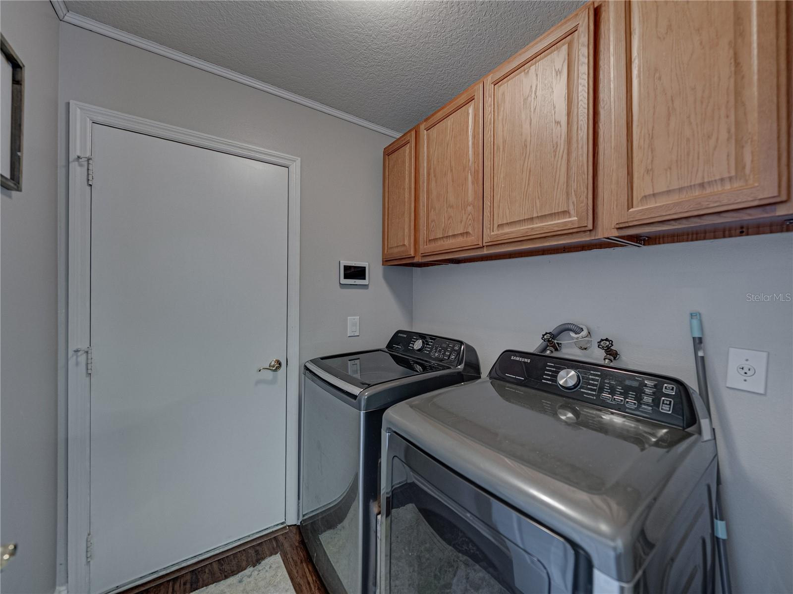 Laundry Room with Washer/Dryer Included and Solid Wood Cabinetry