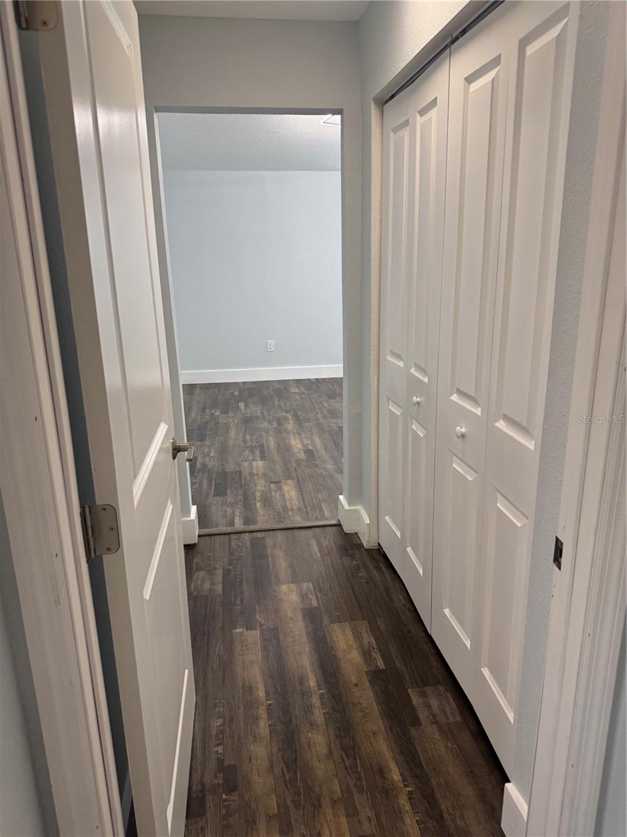 Walk area with closet into primary bedroom
