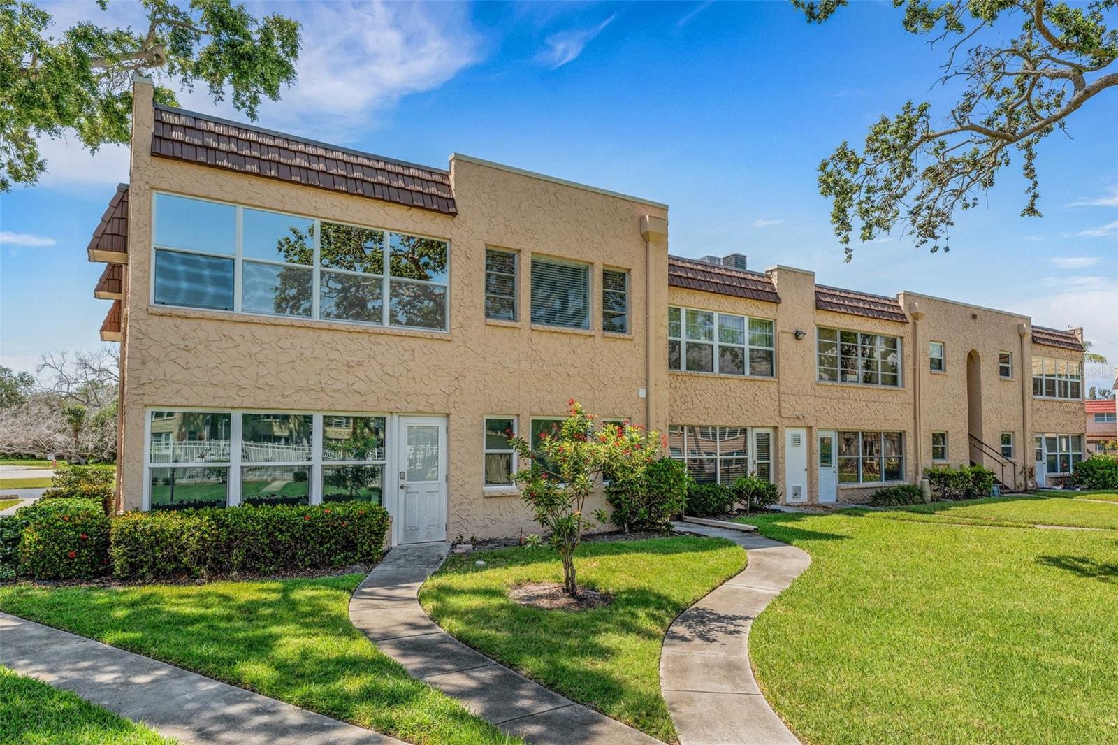 Rear of Unit with Sidewalk to Pool and Clubhouse