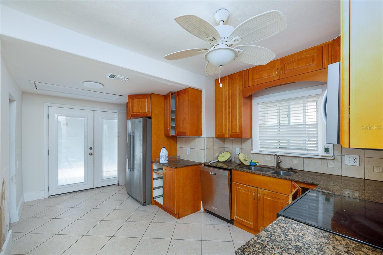 Kitchen. Storm-rated French doors to covered rear porch.