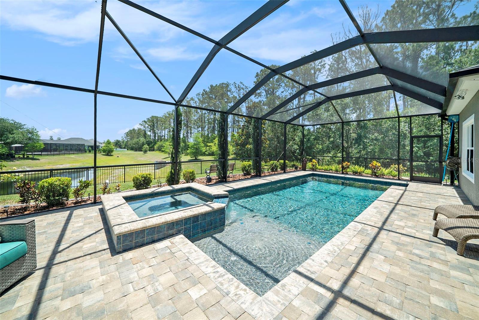 Pool and spa with pavered and screened patio.