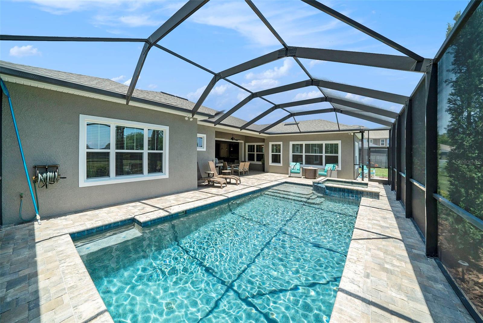Pool with pavered patio and screened enclosure