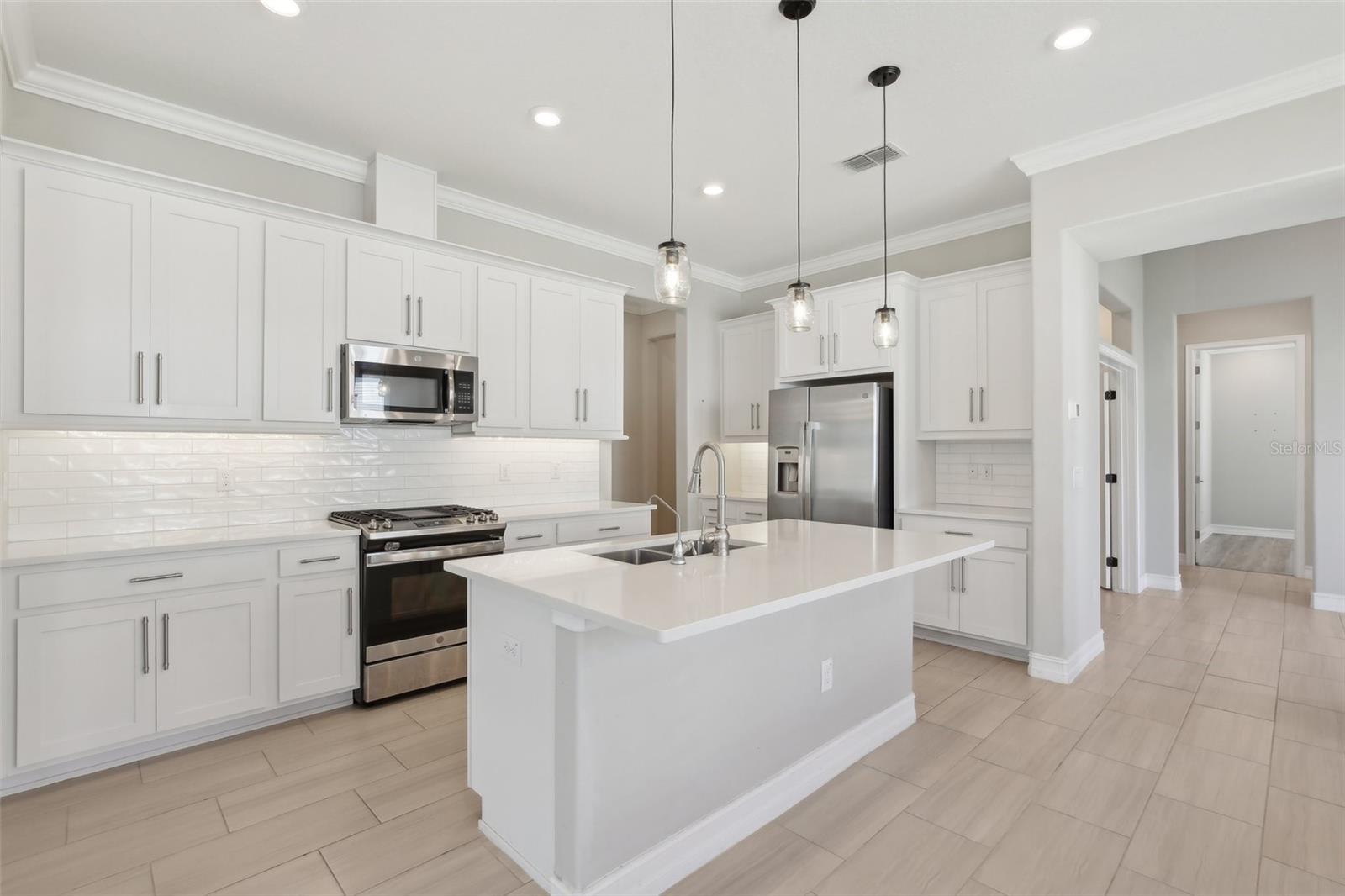 BRIGHT, OPEN KITCHEN LENDS TO PLENTY OF SPACE FOR ENTERTAINING