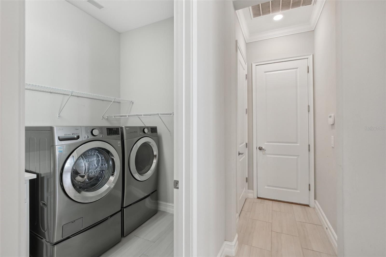 LAUNDRY ROOM HAS CONVENIENT BUILT-IN LAUNDRY TUB WITH STORAGE