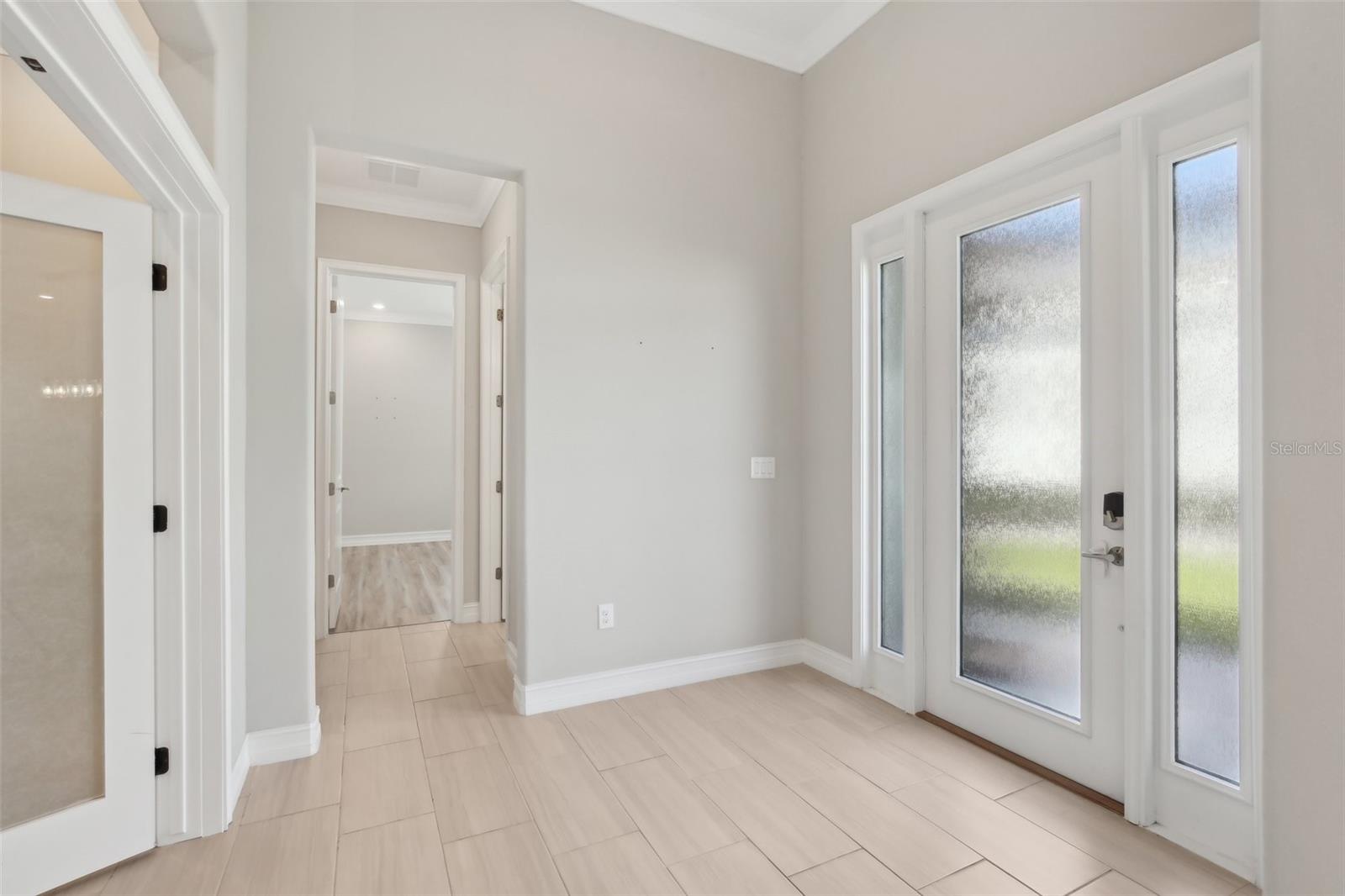 OPEN ENTRY HAS BEDROOM 2 ON THE RIGHT AND OFFICE/DEN WITH DOUBLE GLASS DOORS