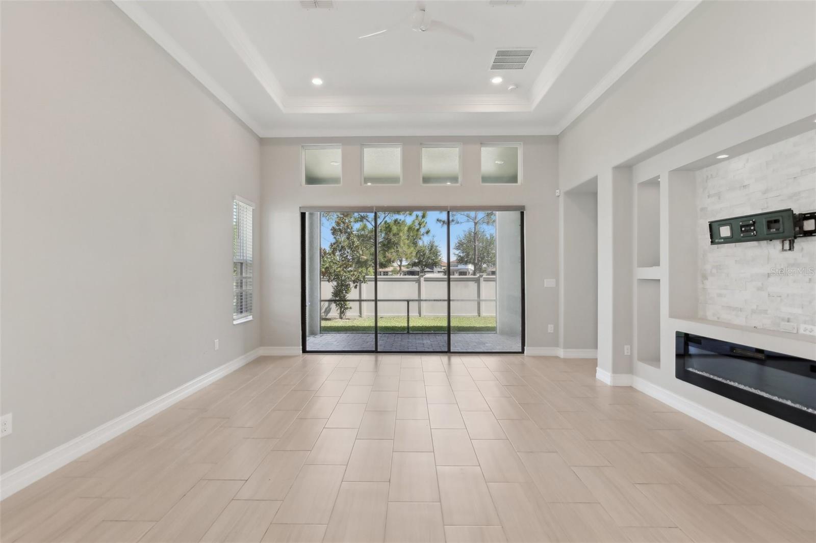 LARGE LIVING ROOM WITH BUILT-INS AND DECORATIVE FIRE PLACE