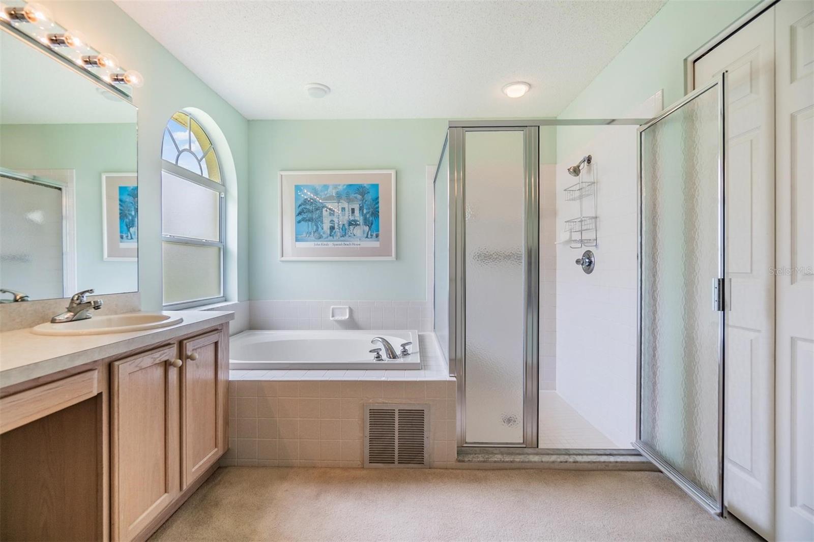 Garden tub adjoins the step-in shower