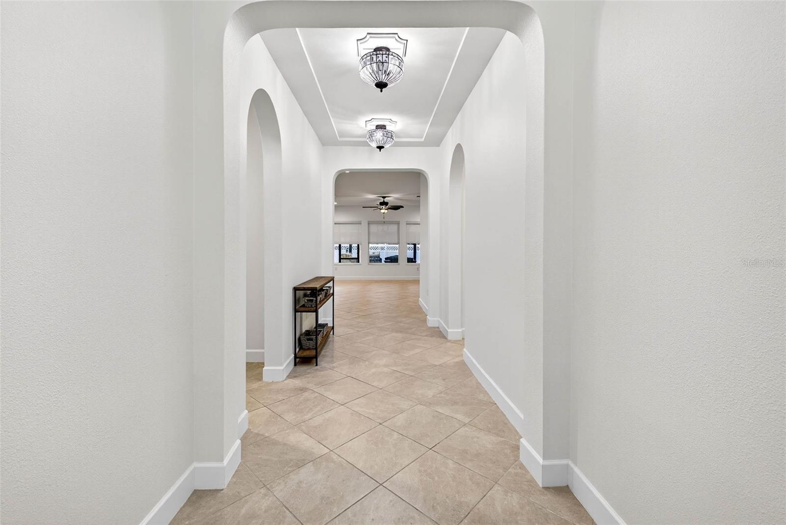 Warm & inviting entryway with new lighting fixtures and tall ceilings