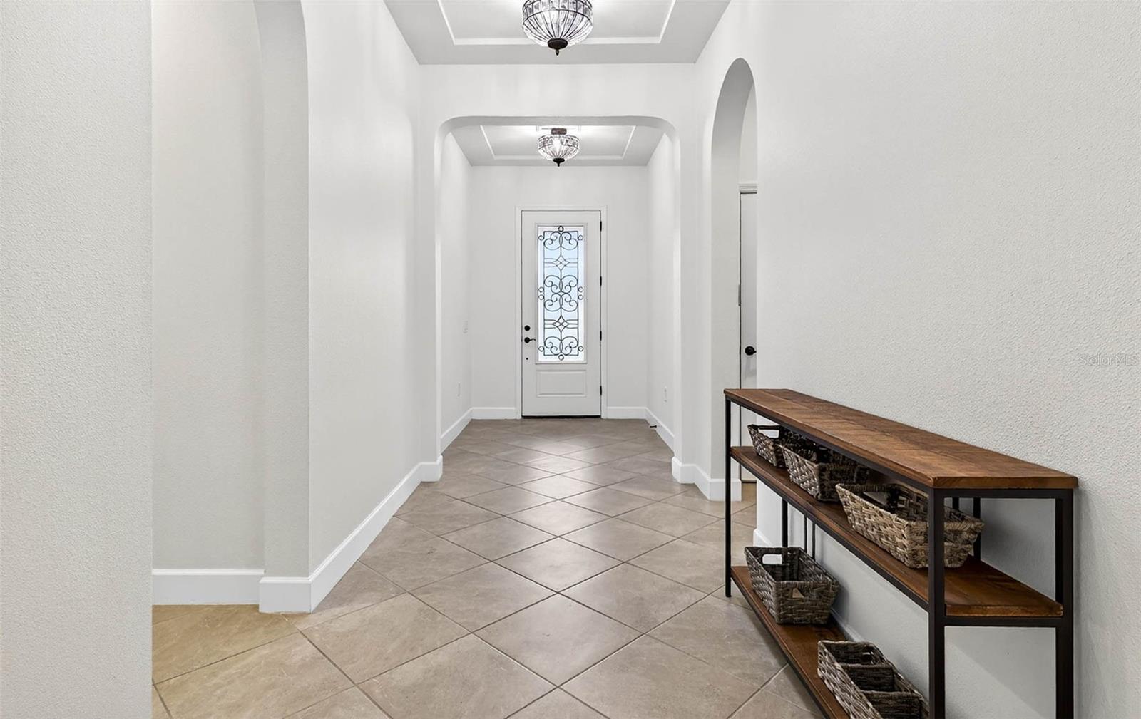 Entryway highlights the 3 way split floorplan of the home. BR4 to the R, BR 2 & 3 to the L, Primary in the back.