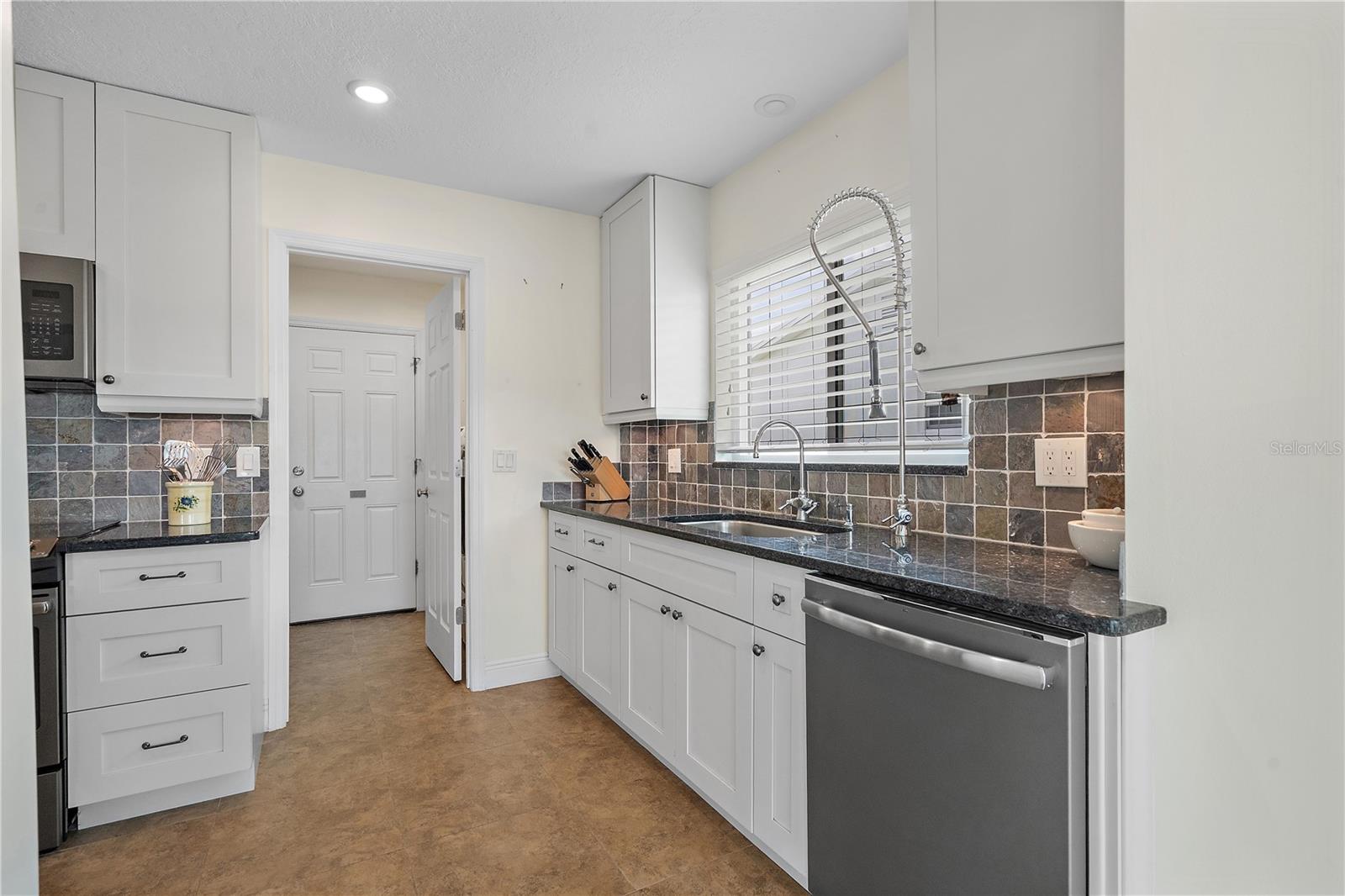 The cleanup side of the kitchen opens to the laundry room then to the garage