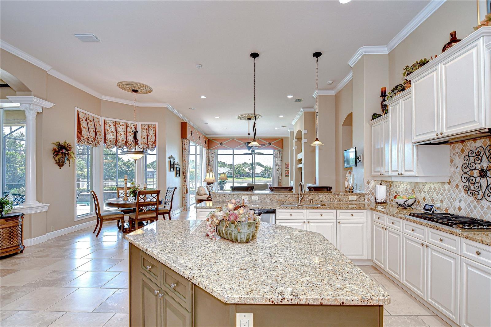 Kitchen open to Cafe Area and Family Room, Columns on the Left Separate the Forman Living Room