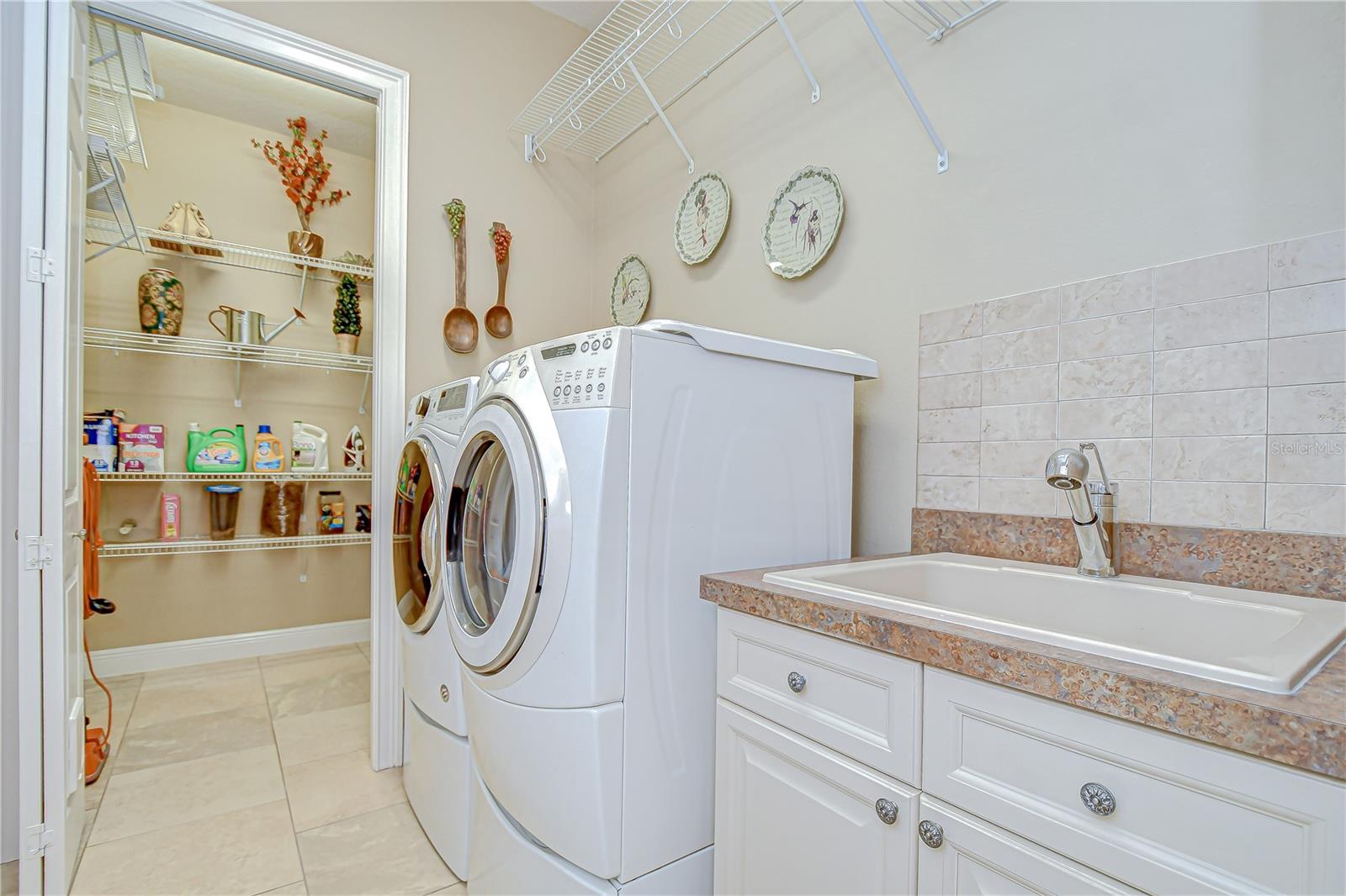 Laundry Room, Washer/Dryer, Sink Base, Storage Room Beyond