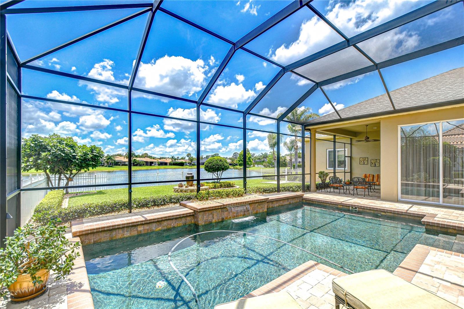Large Custom Designed Pool with Sheer Descent Waterfall Feature, Lakefront, Wrap Around Lanai