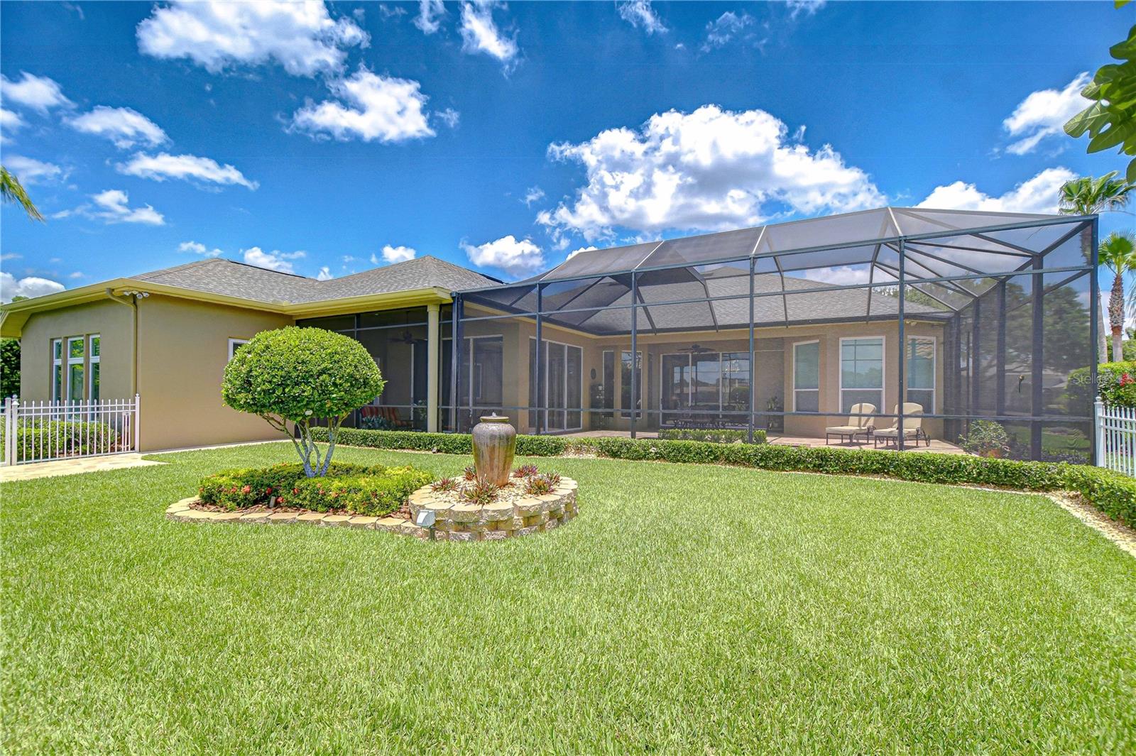 Backyard Beyond the Screen Enclosure, Waterfront, Landscape Island with Fountain Feature, Paver Walkway Along the Fence Side