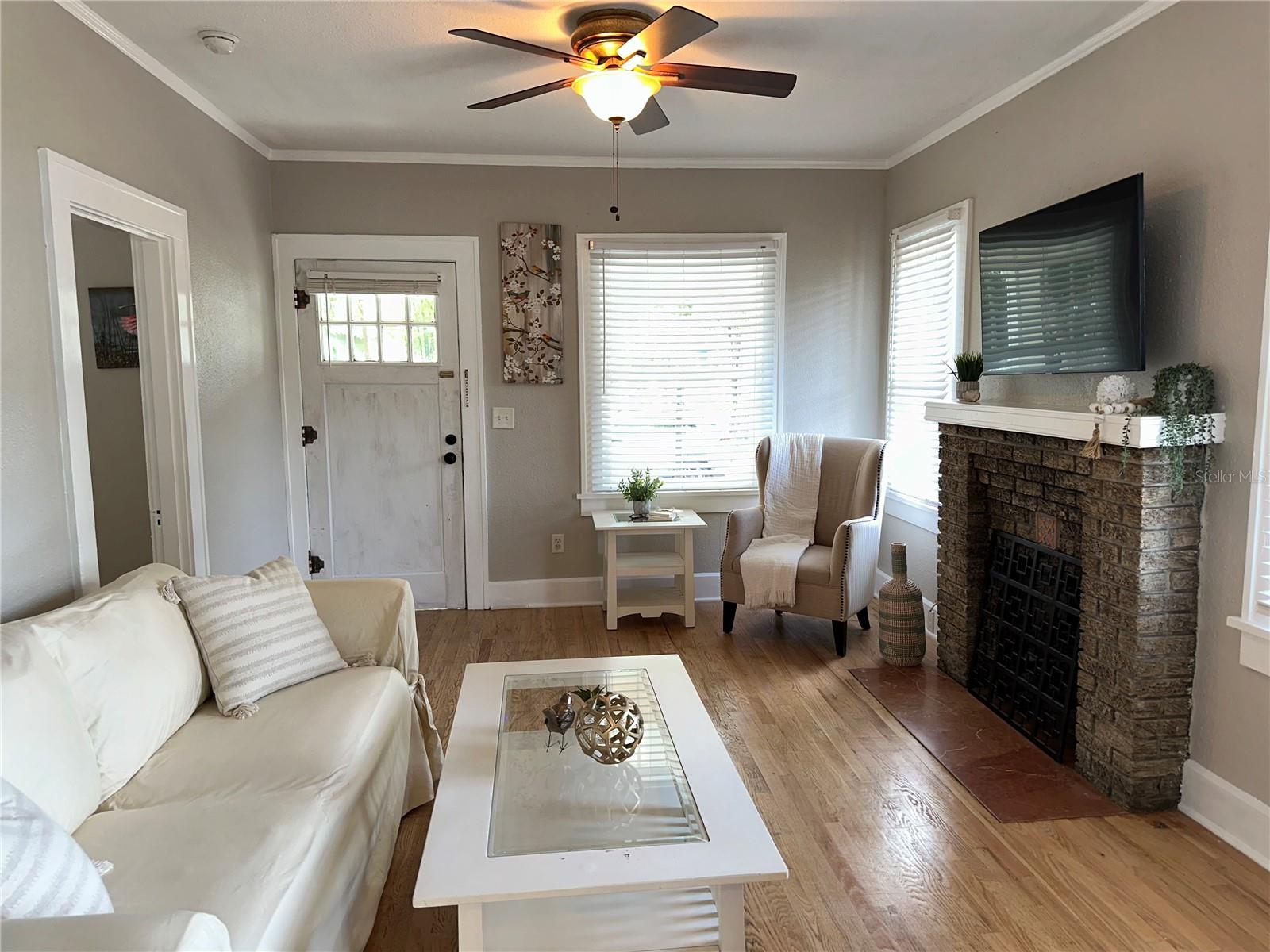 The living room has a beautiful fireplace & lots of natural light.