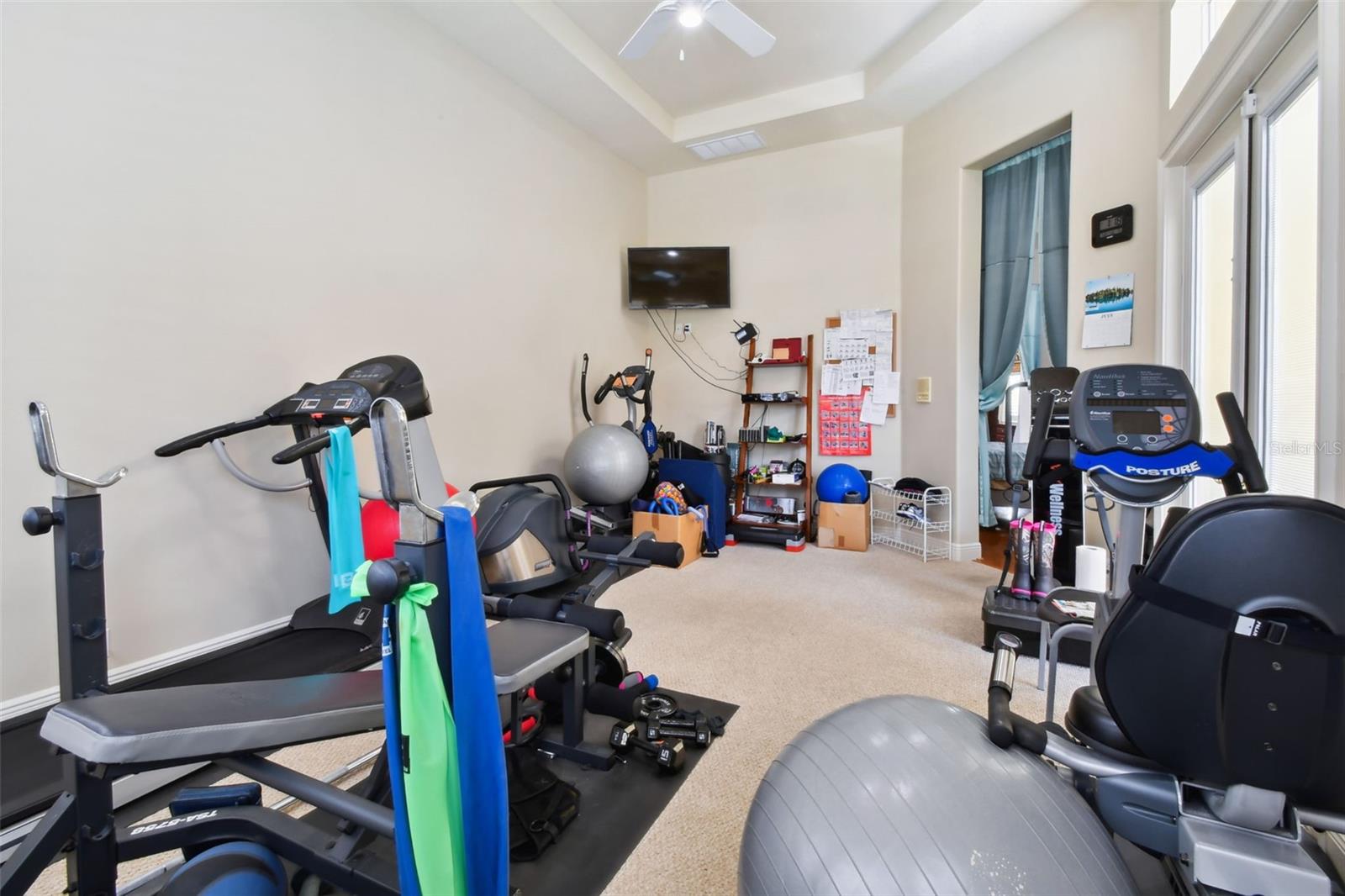 Gym room with pool access and views out towards the rear garden.