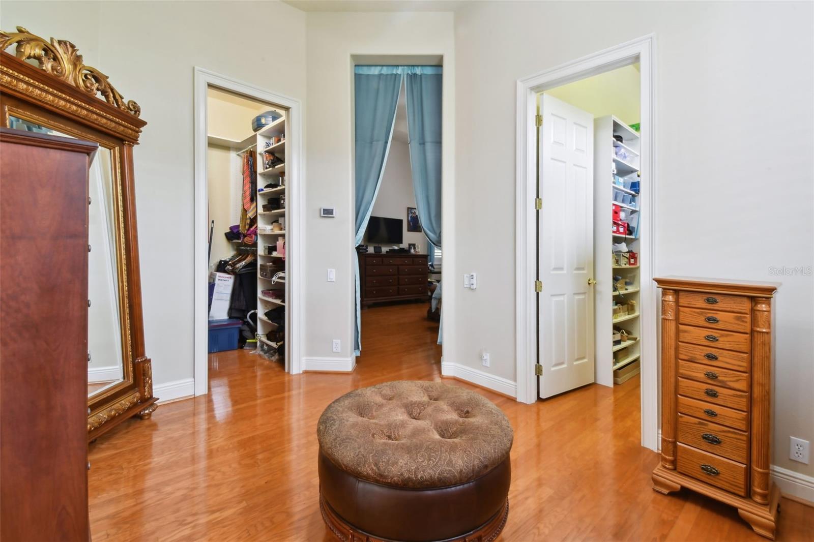 Dressing room with view towards both walk-in closets.