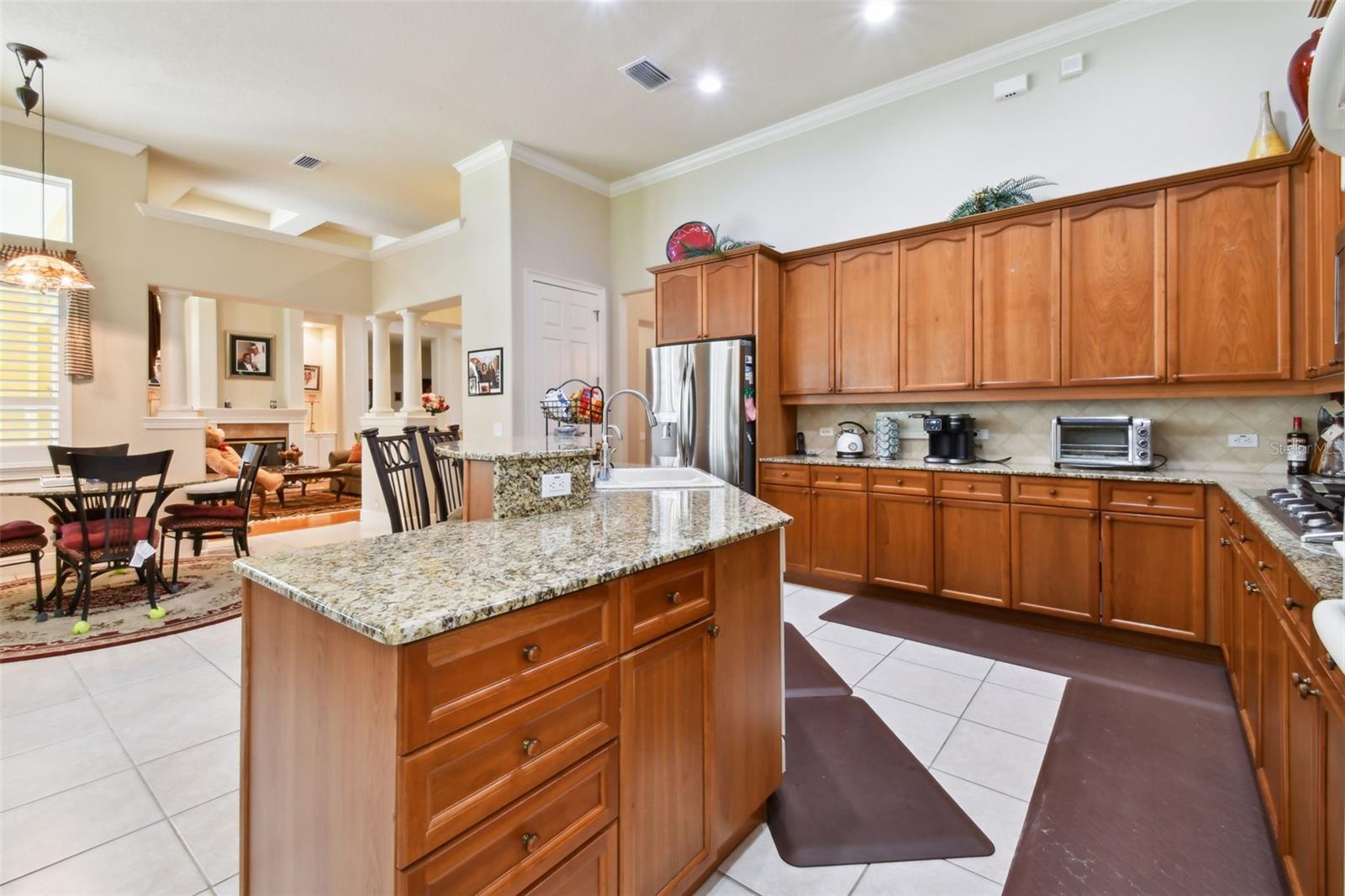 Kitchen with granite counters and solid wood cabinetry.