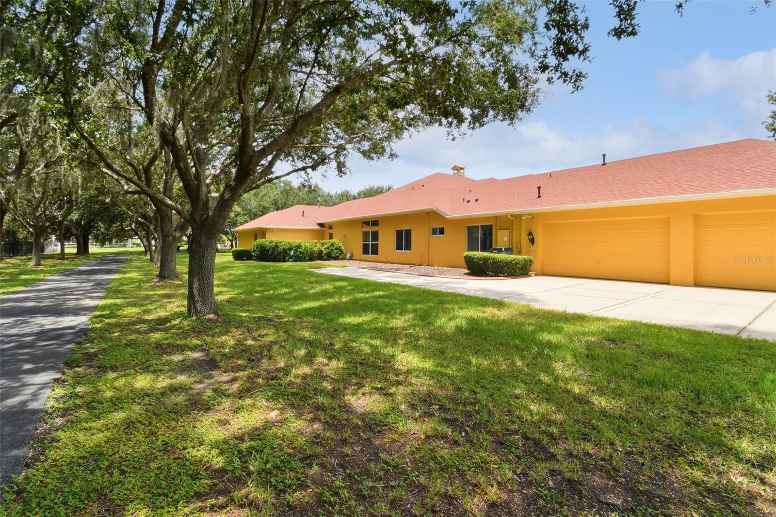 View of the side entry 4 car garage and trail to your left.