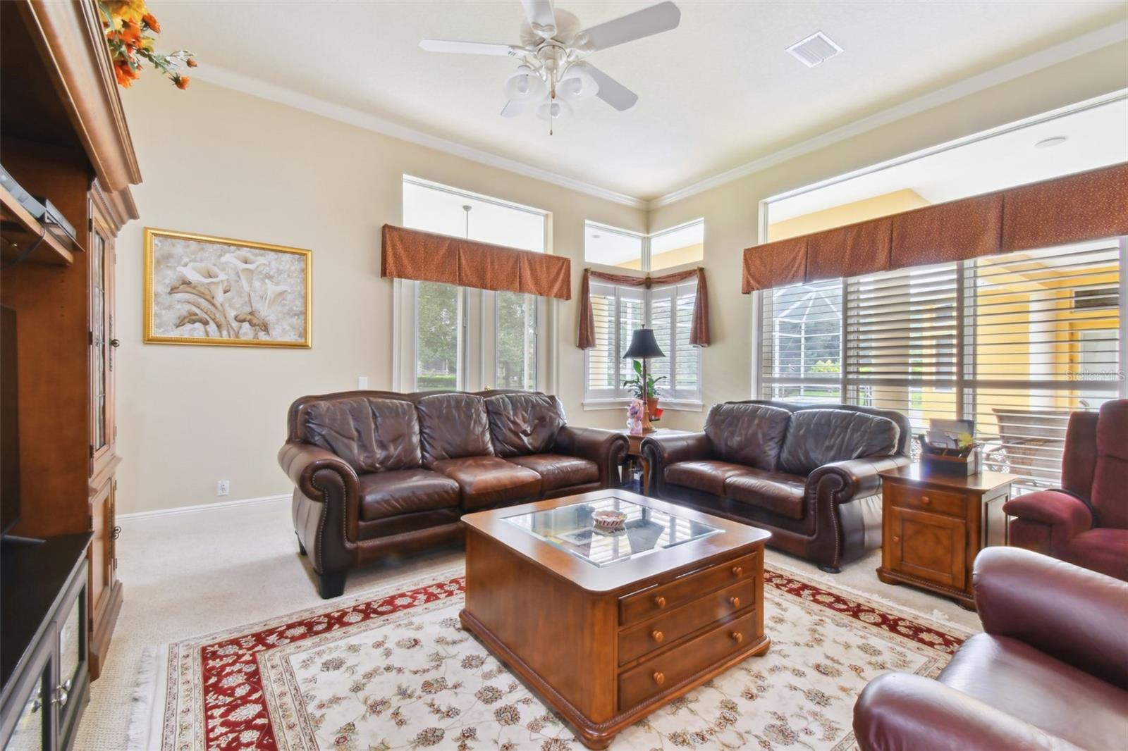 Living room with sliders and French doors out to the pool.