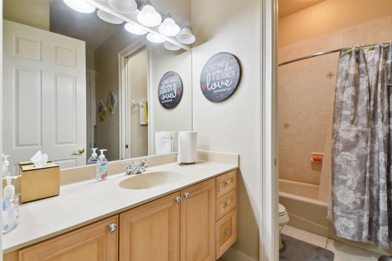 Bedroom 2 en-suite with vanity and tub.