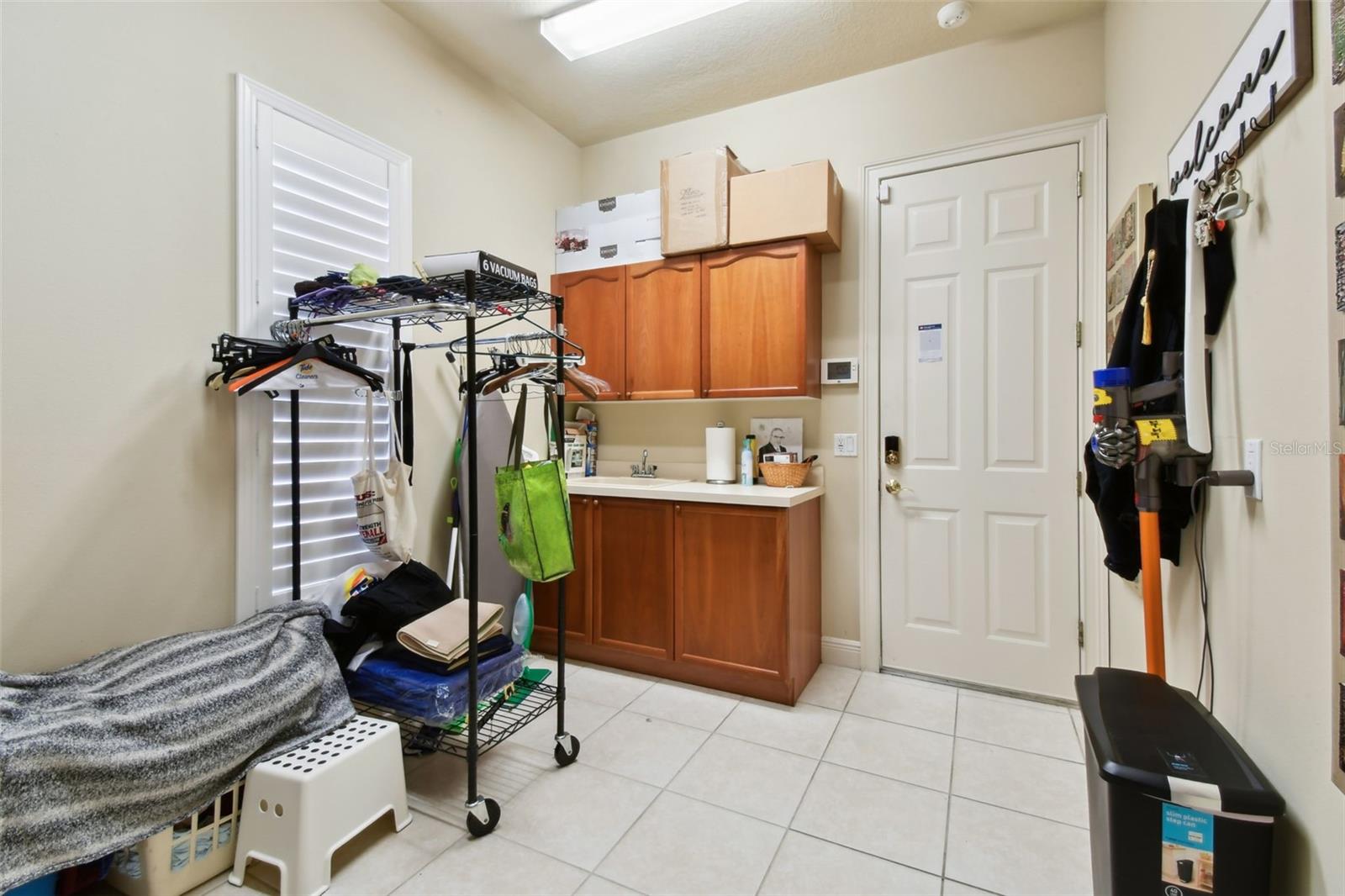 Laundry room with plenty of cabinetry.