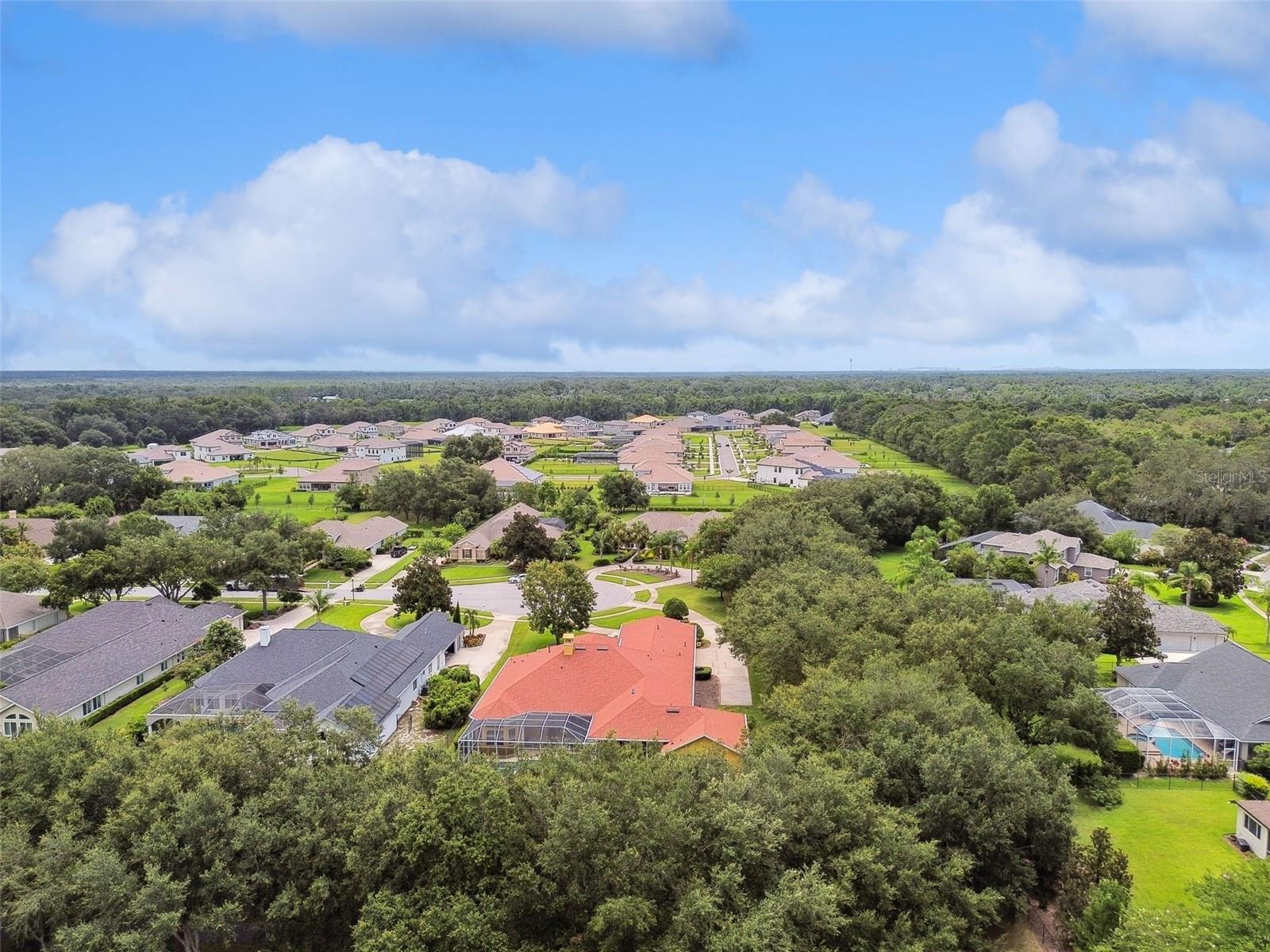 Aerial view with home surrounded by Trails.
