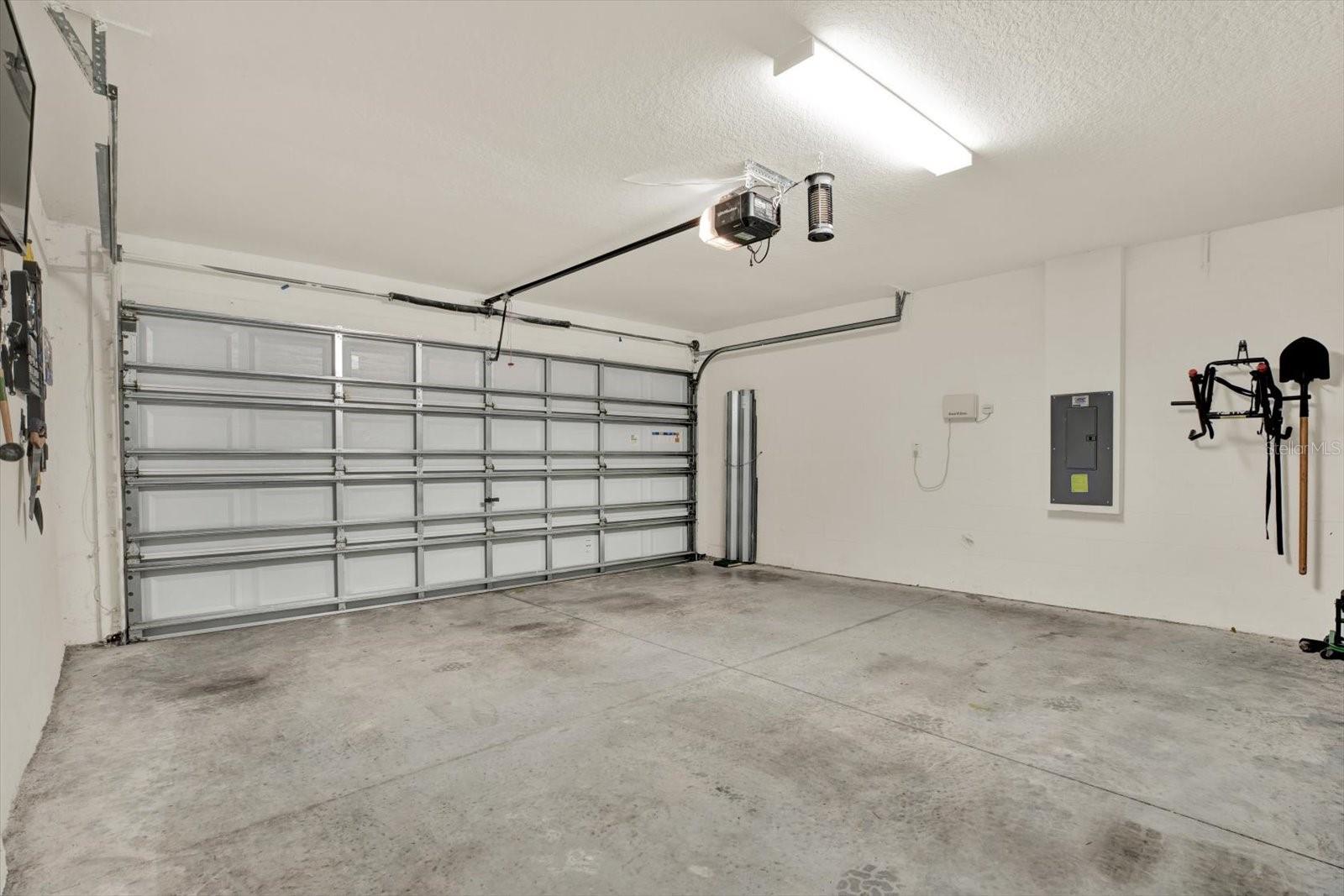 GARAGE FOR CAR CARS AND STORAGE  HURRICANE SHUTTERS  FOR ALL THE WINDOWS NEATLY STORED