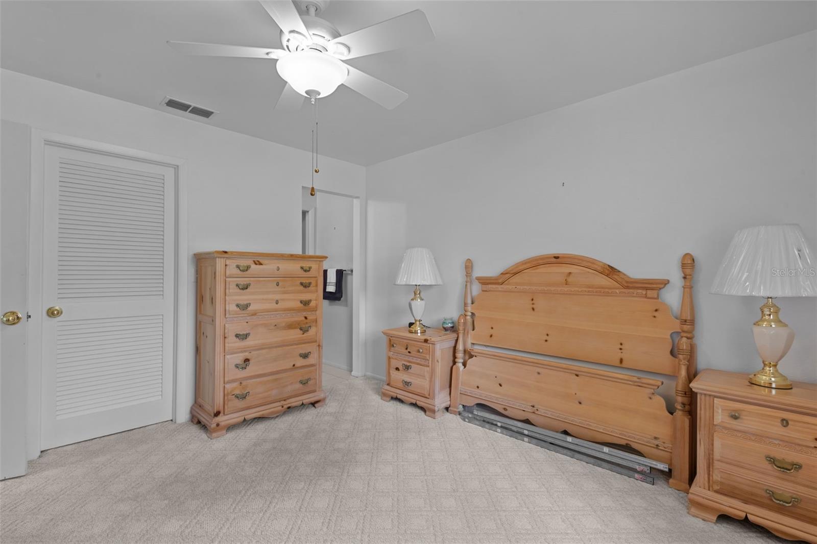 Primary Bedroom showing door to walk in closet and opening to en suite bathroom