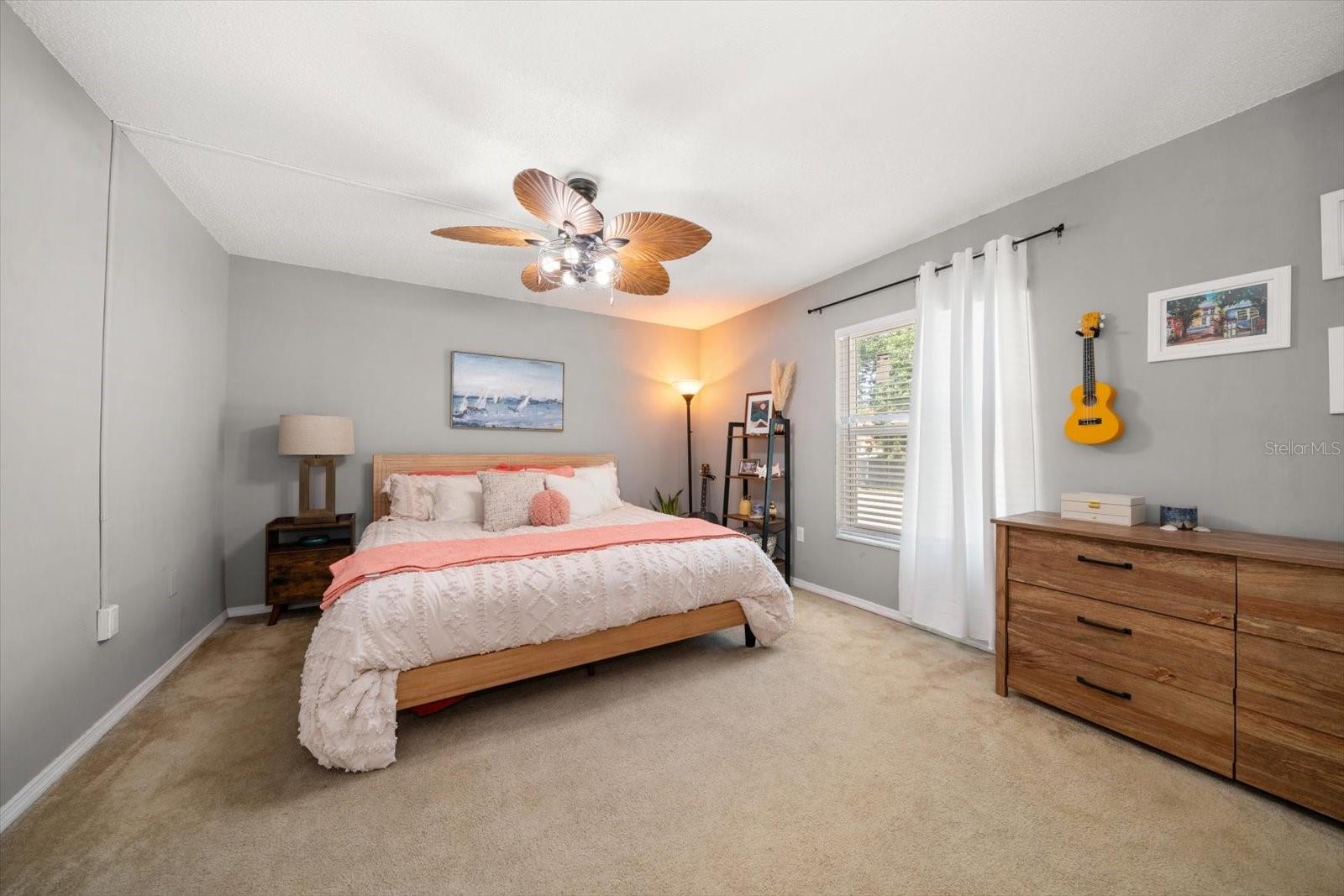 Tranquility and serenity is maximized in this ample primary bedroom.