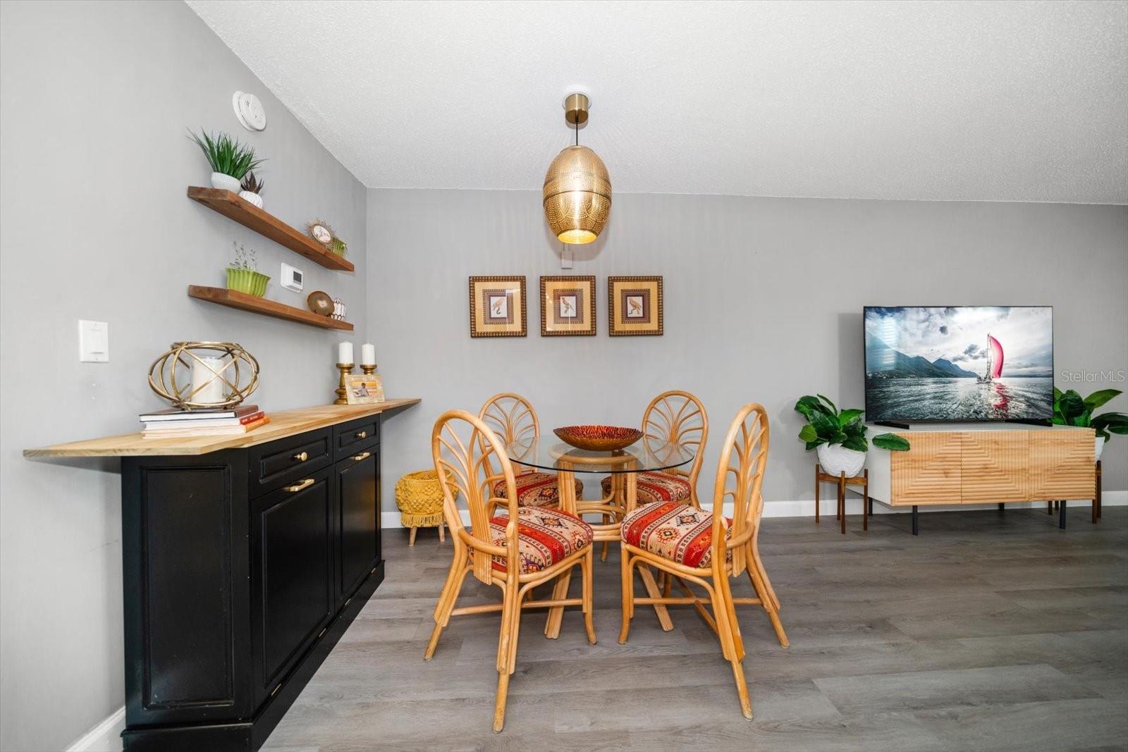 Living spaces follow seamlessly throughout the home from the dining room to the living area.