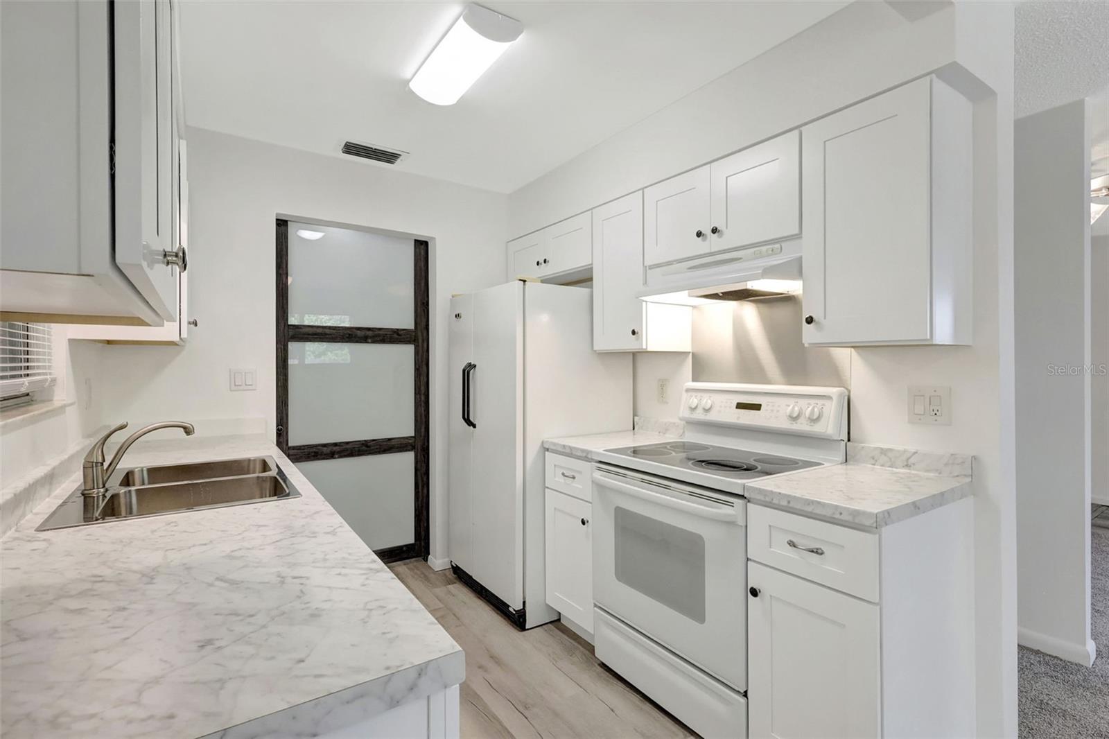 New cabinets, countertops, sink and faucet, barndoor, lighting!