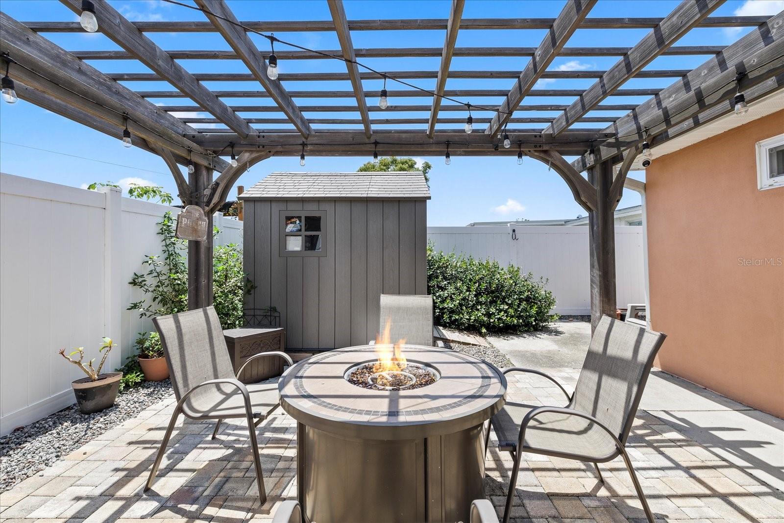 8x8 all weather storage shed near firepit/pergola