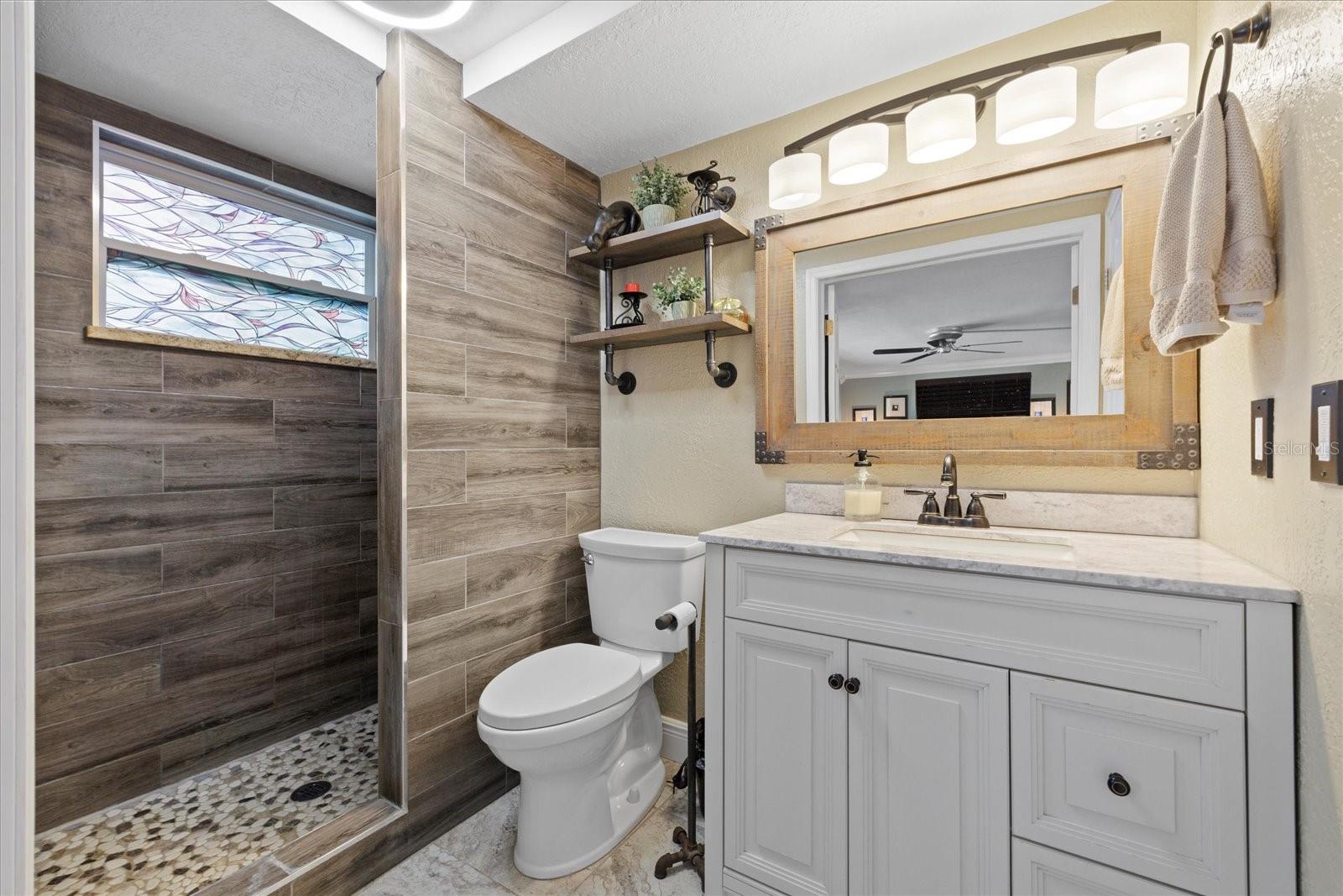 Primary bathroom with walk in shower and linen closet