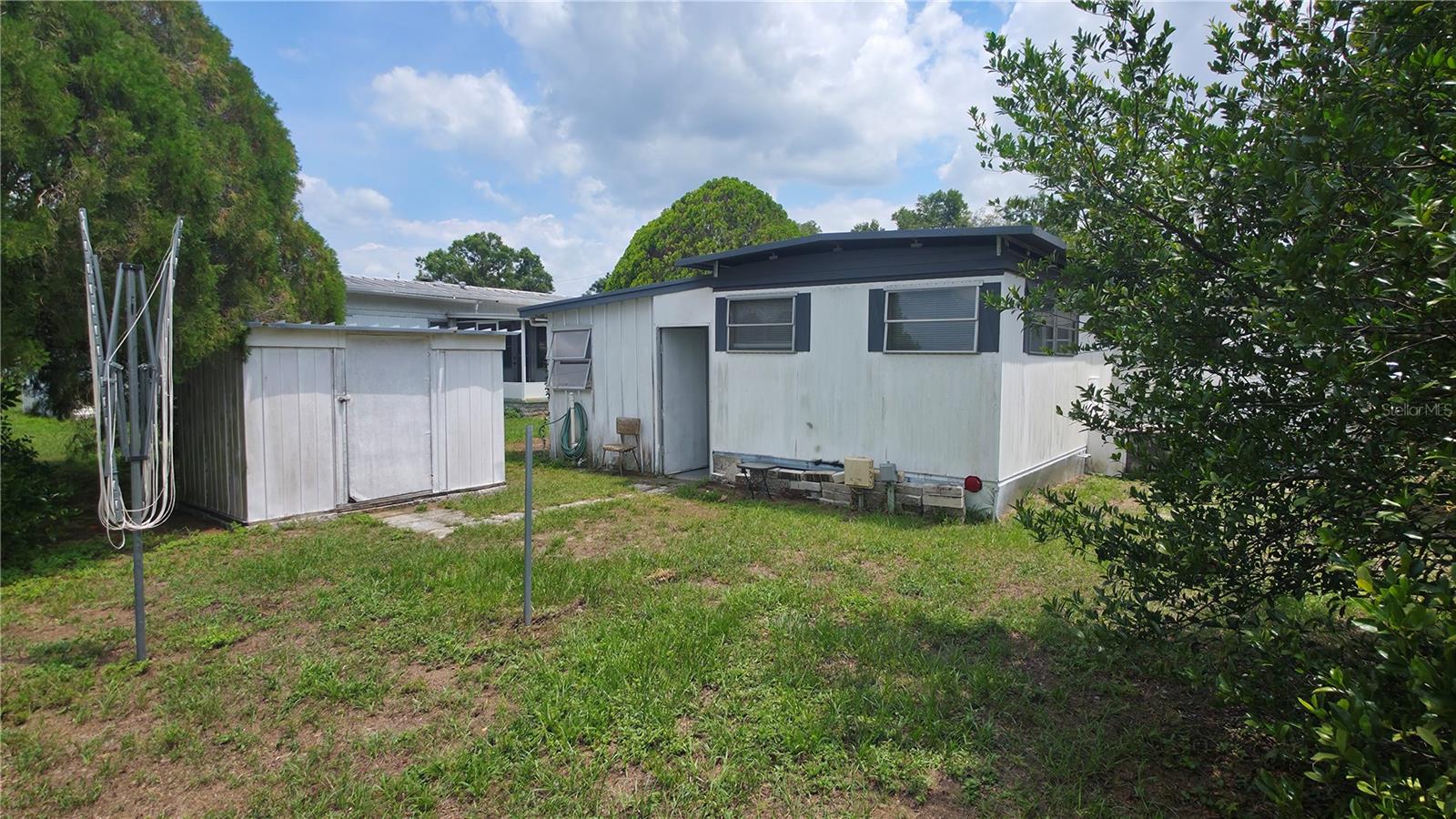 Back yard with shed & umbrella clothesline.