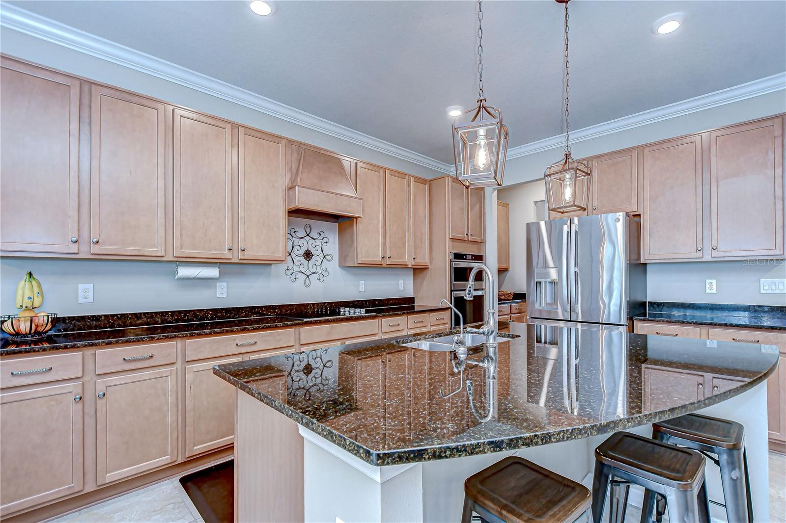 The kitchen features granite countertops, a large island with breakfast bar, and 42" cabinets!