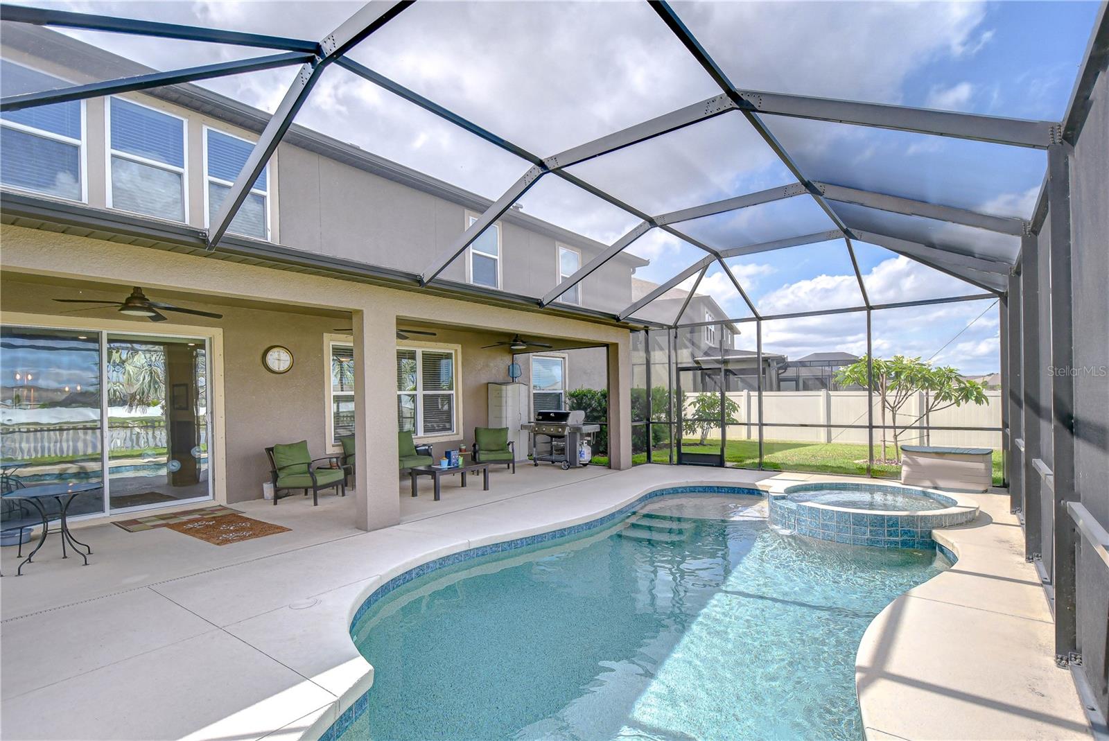 Step outside to your private outdoor retreat, complete with an extended screened lanai, a heated pool and spa!