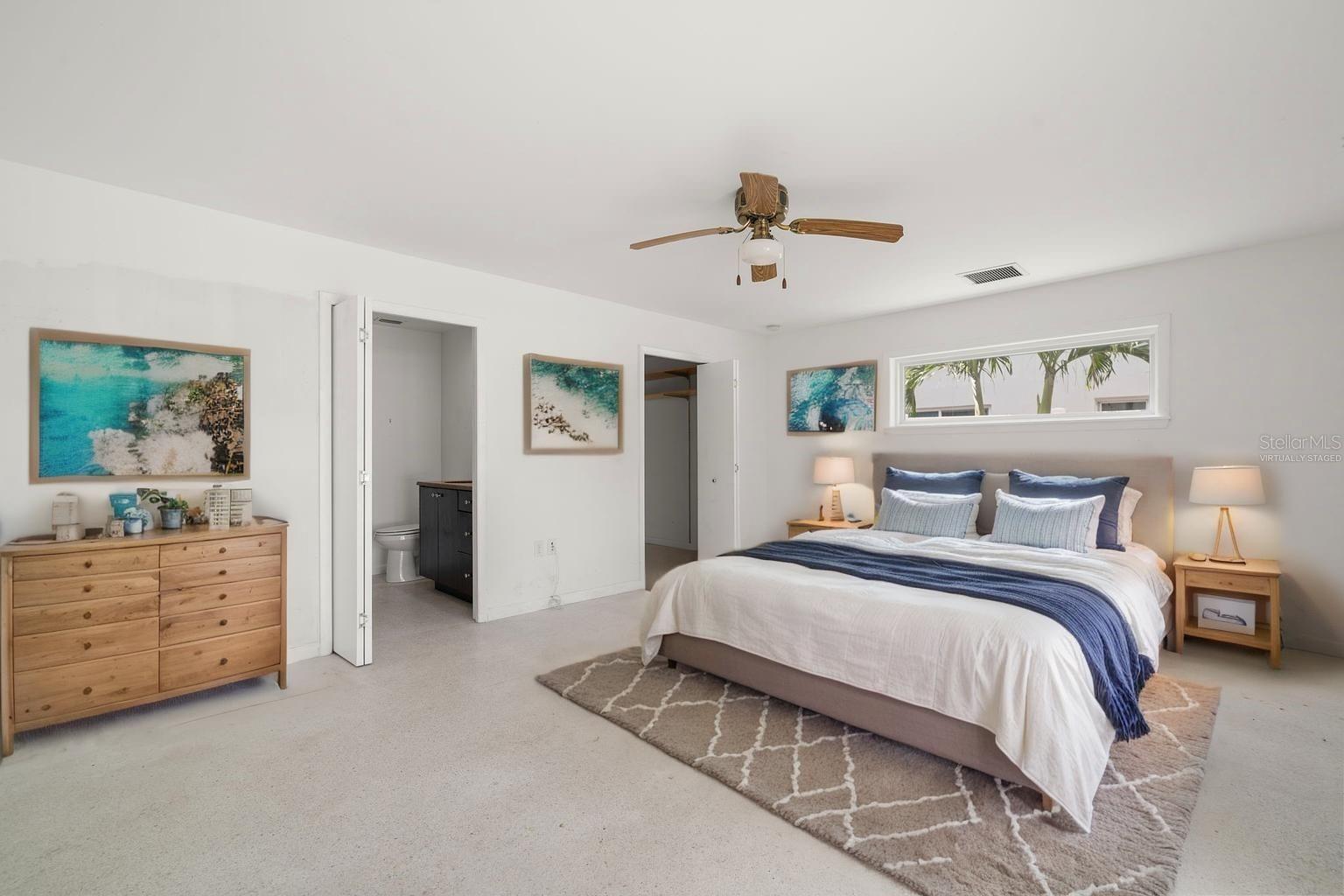 Your Primary Suite. This is a spacious room filled with natural light, huge walk-in wardrobe and ensuite bath. (Virtually staged)