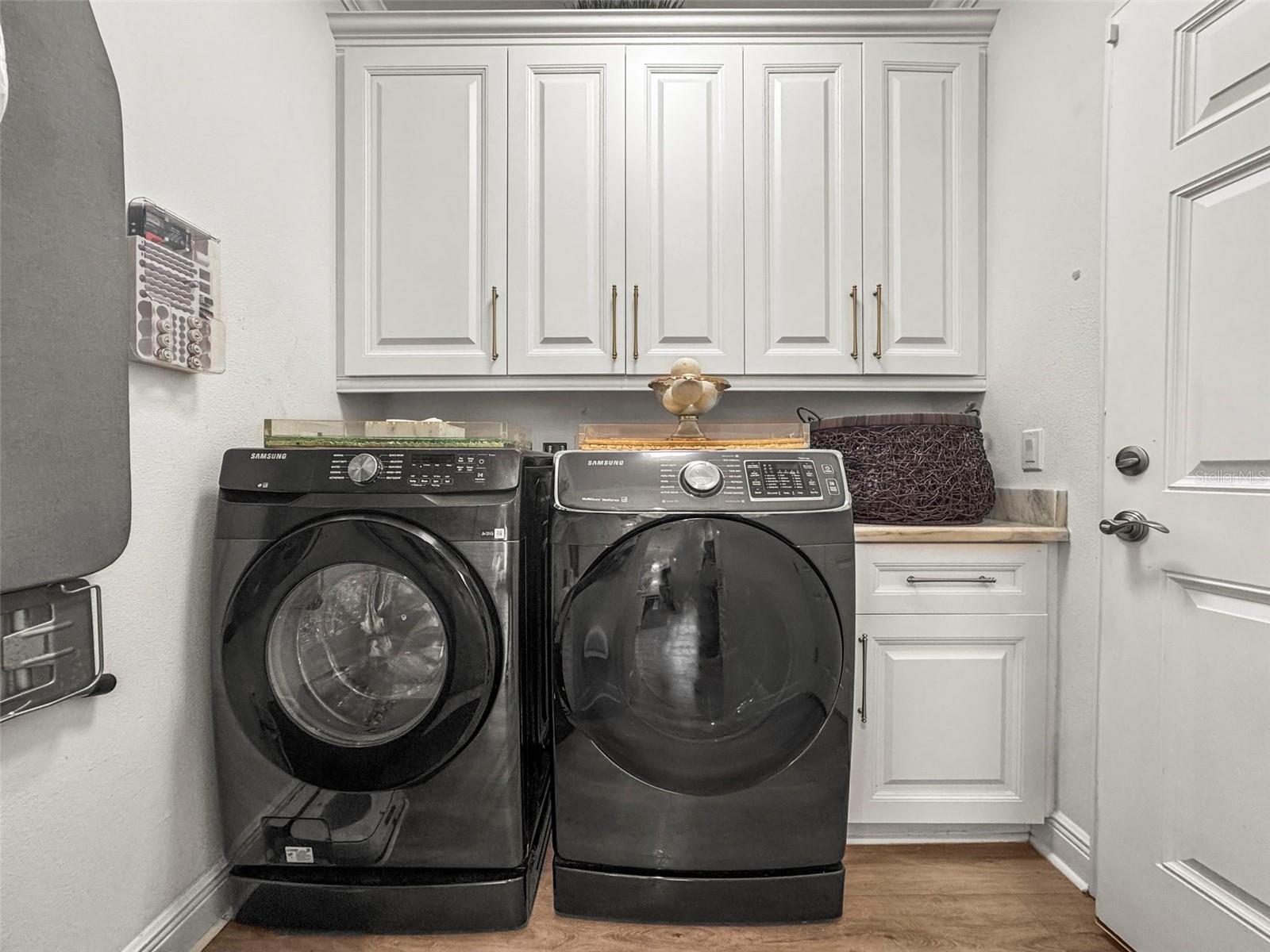Laundry room with plenty of cabinetry and counter top