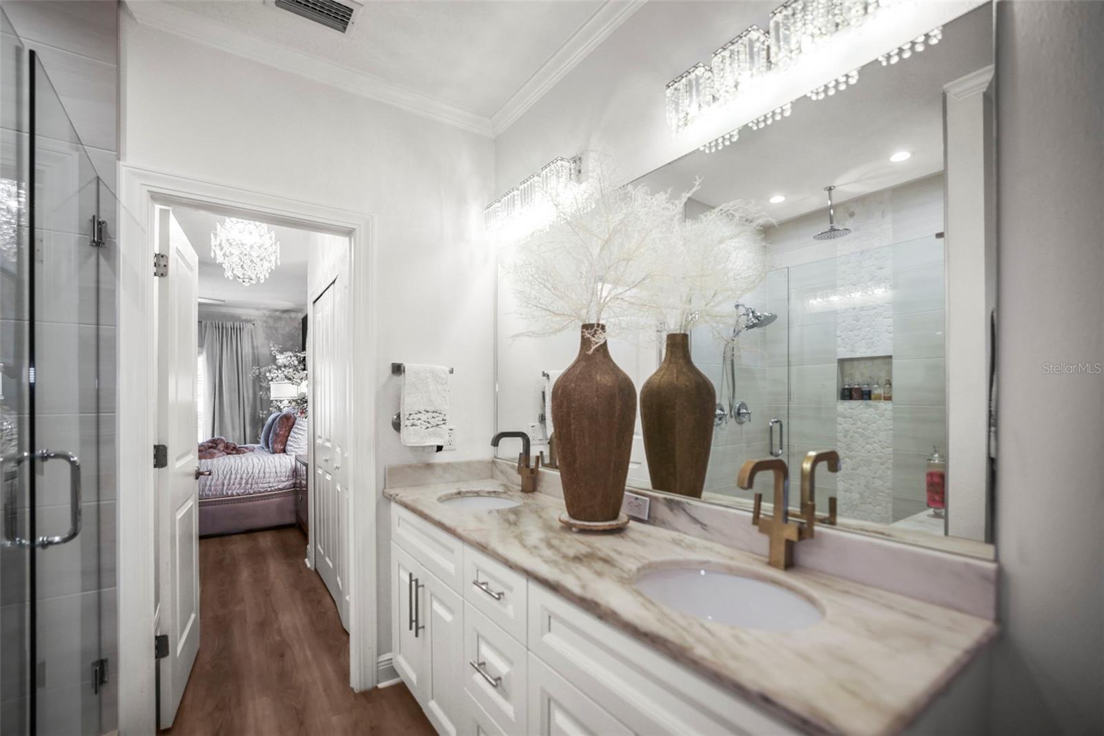 Double sinks with marble counters in primary bathroom