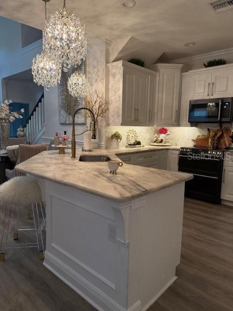 Large kitchen breakfast bar with crystal lighting