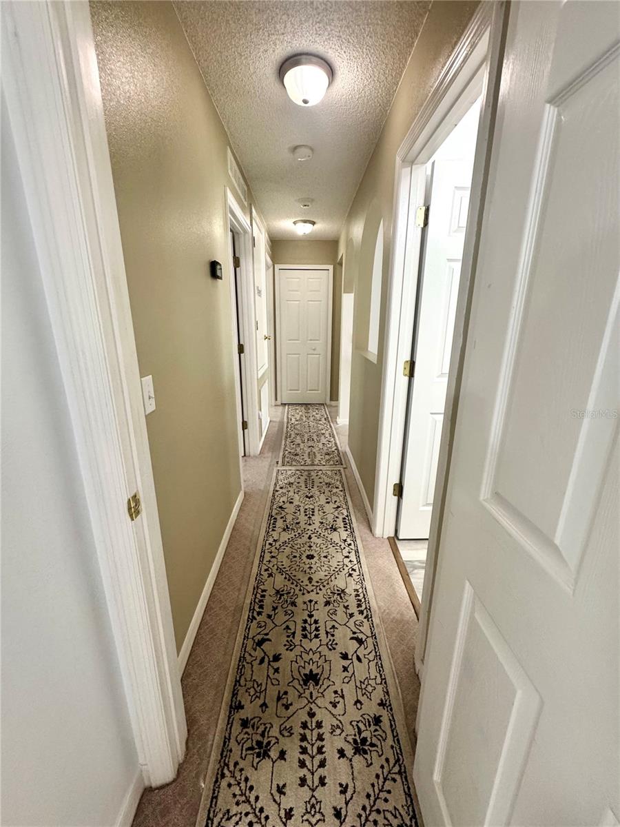 Hallway from Primary to the other 2 bedrooms and Bonus room