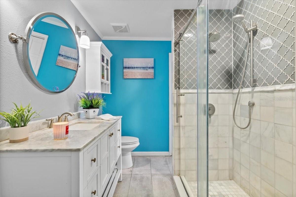 Primary bathroom shower.  View from hallway door