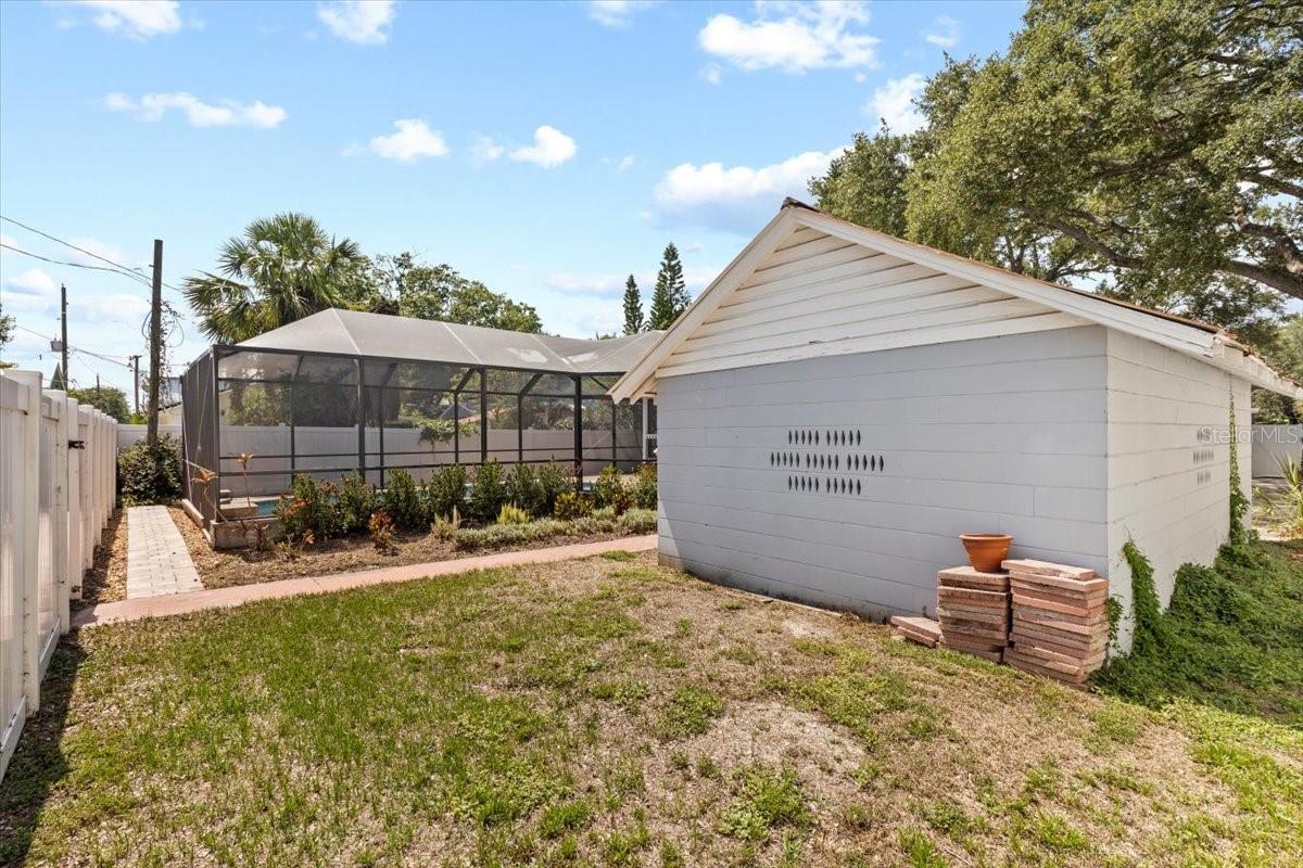 Rear view of detached garage with gate to back alley