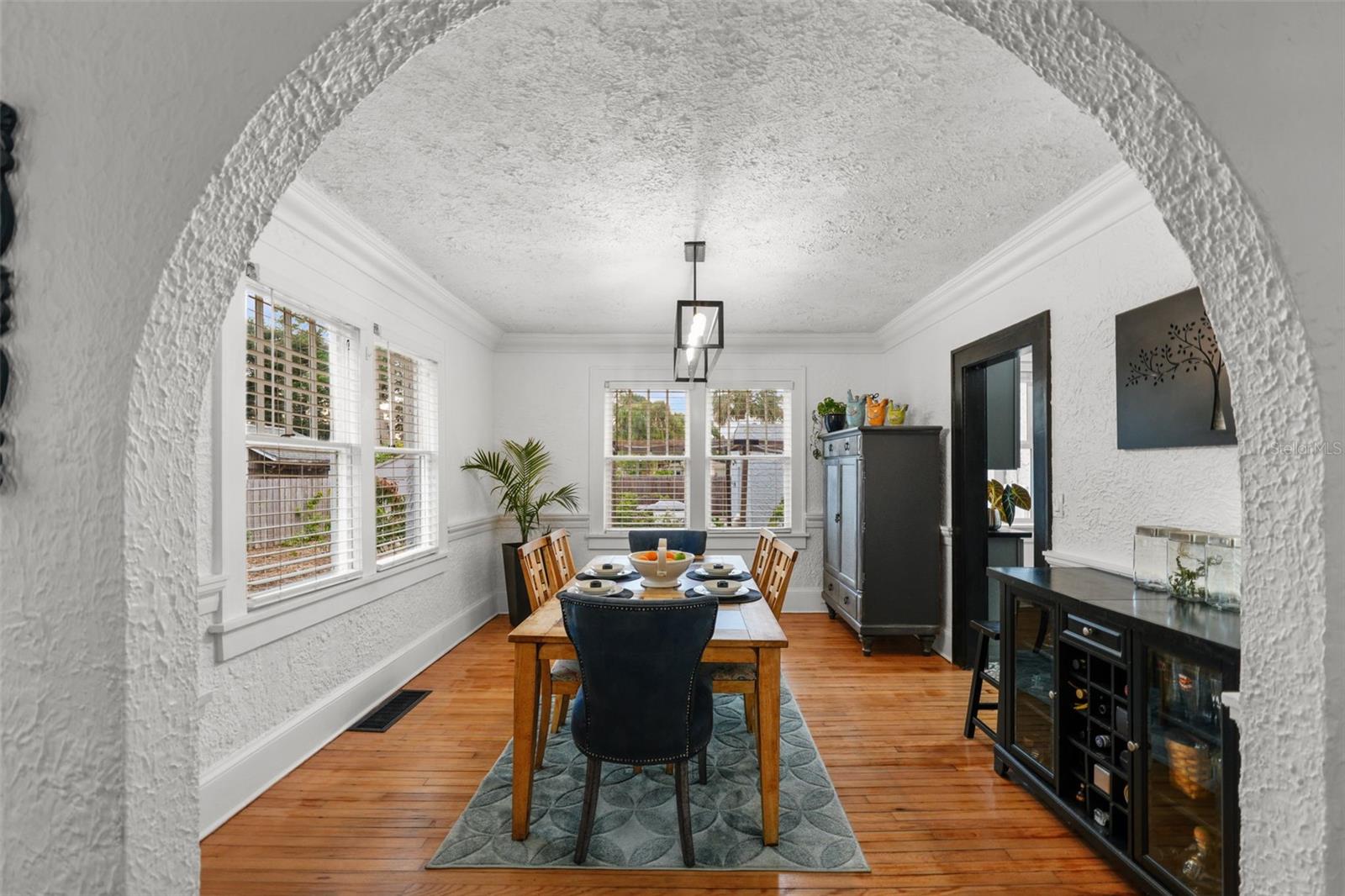 Fabulous dining area receives sunset filtered light through the neighboring vegetation.