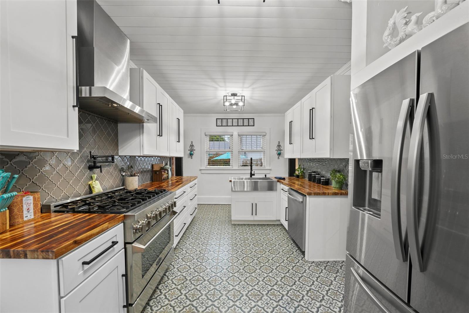 A Chef's kitchen, complete with, deep sink basin, pot filler and gas stove