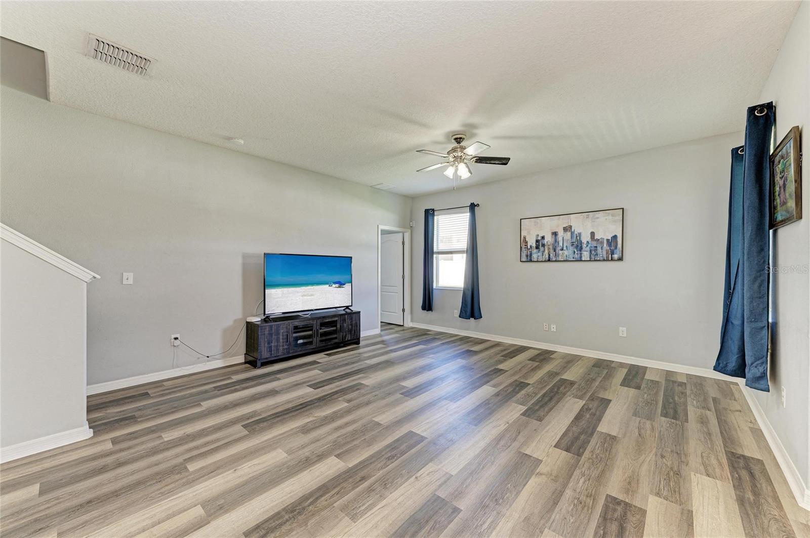 Living room and bedroom/office to the right of the tv