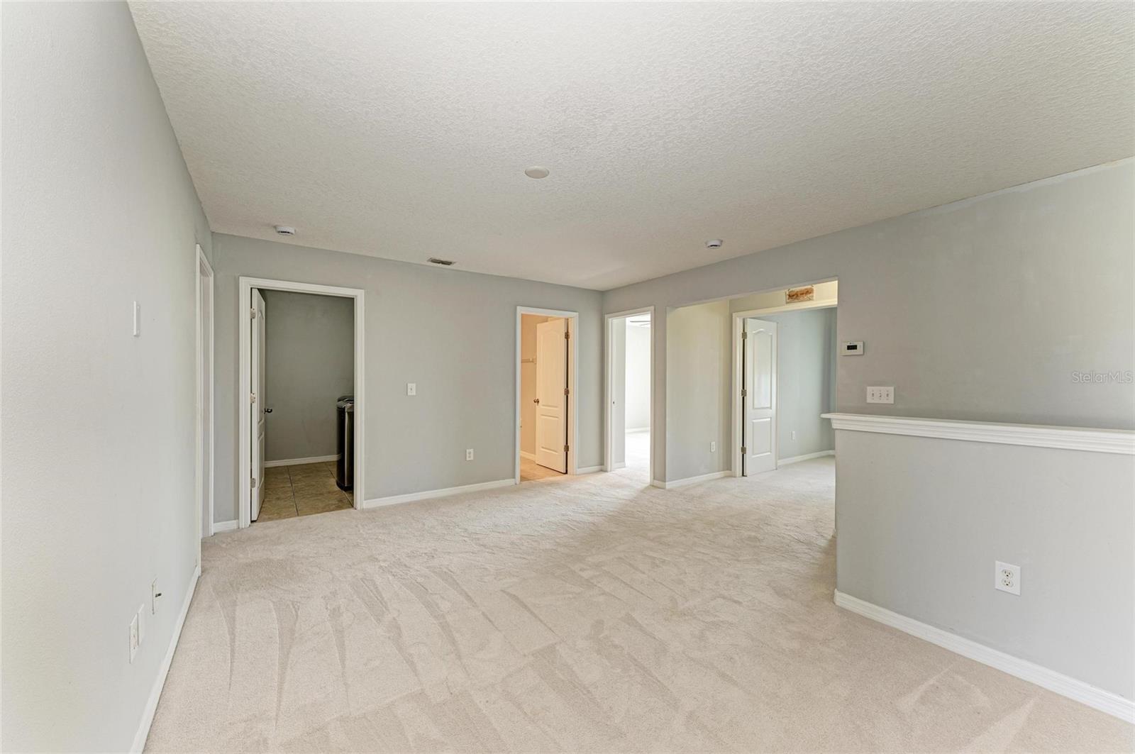 Door to laundry room, bathroom, guest bedroom and primary bedroom