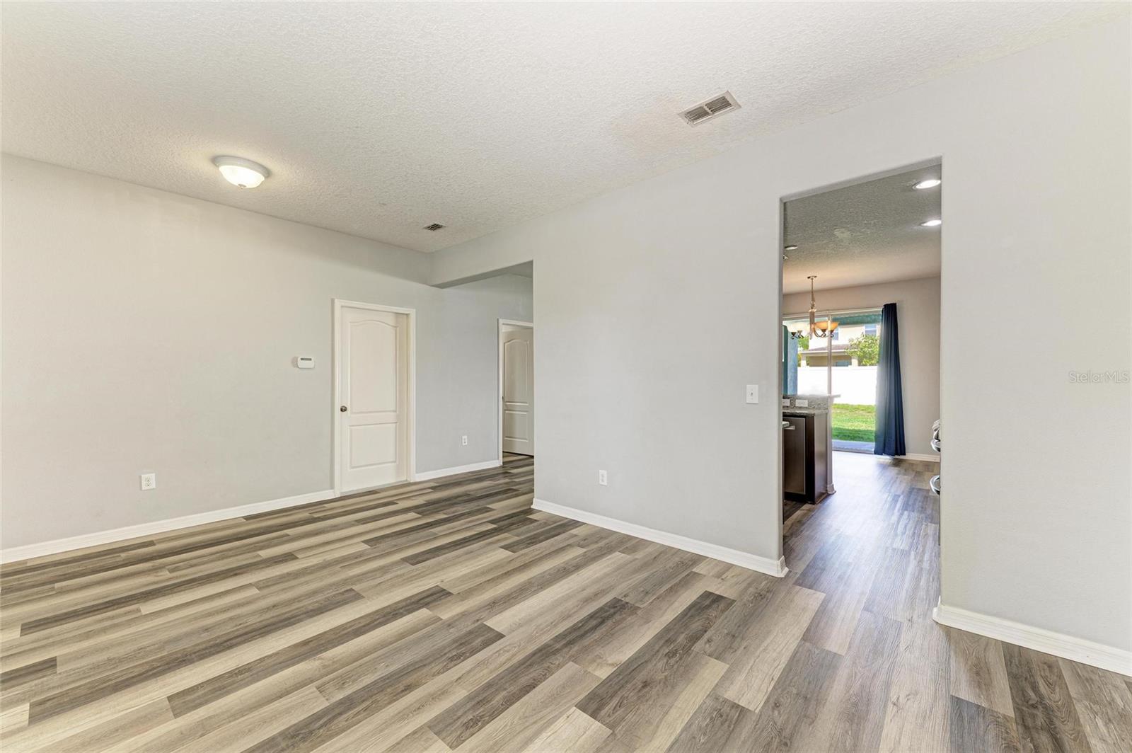 From dining area to kitchen/living room.  Door to the garage.