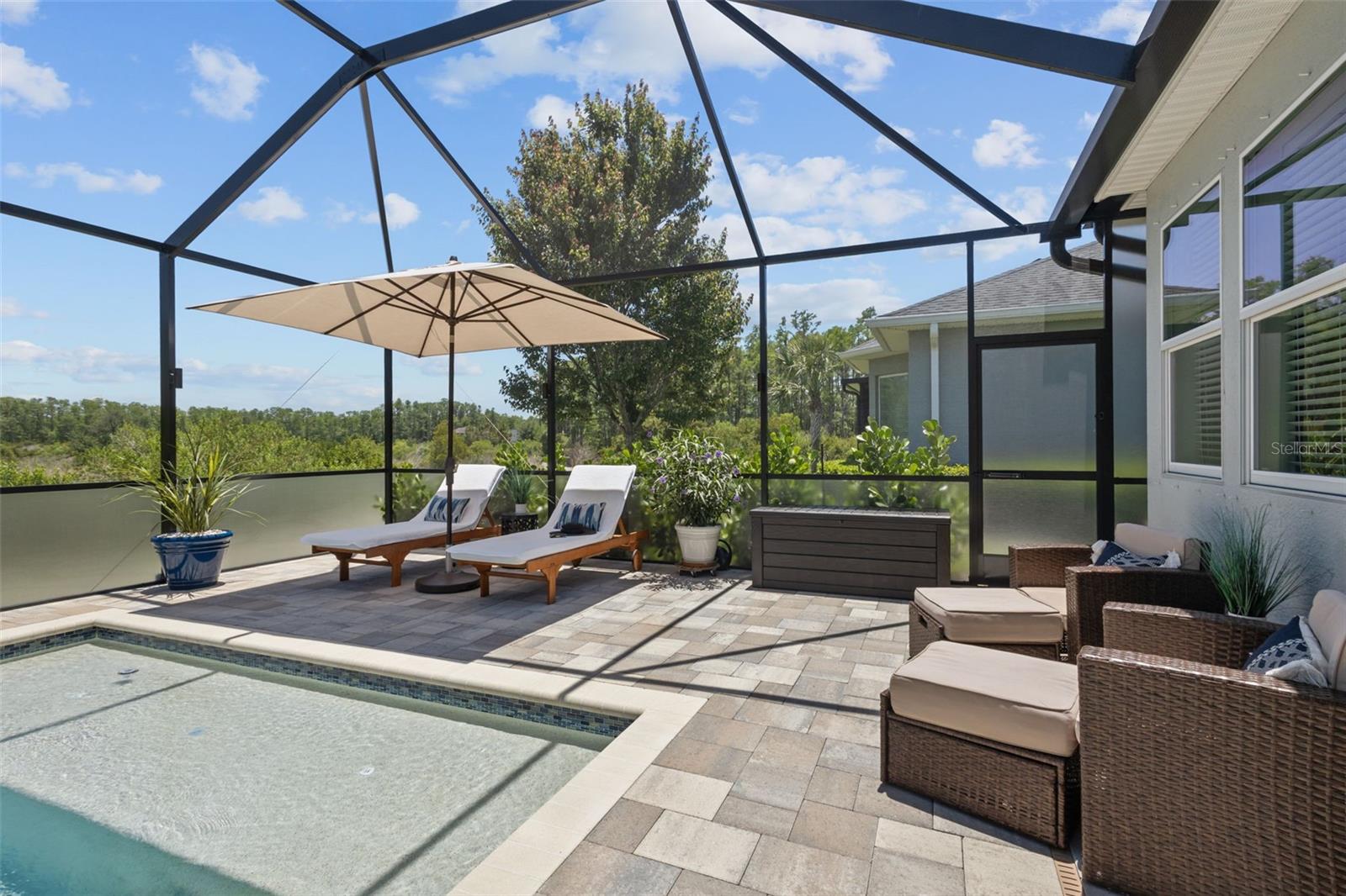 Pool fully caged in with expansive views